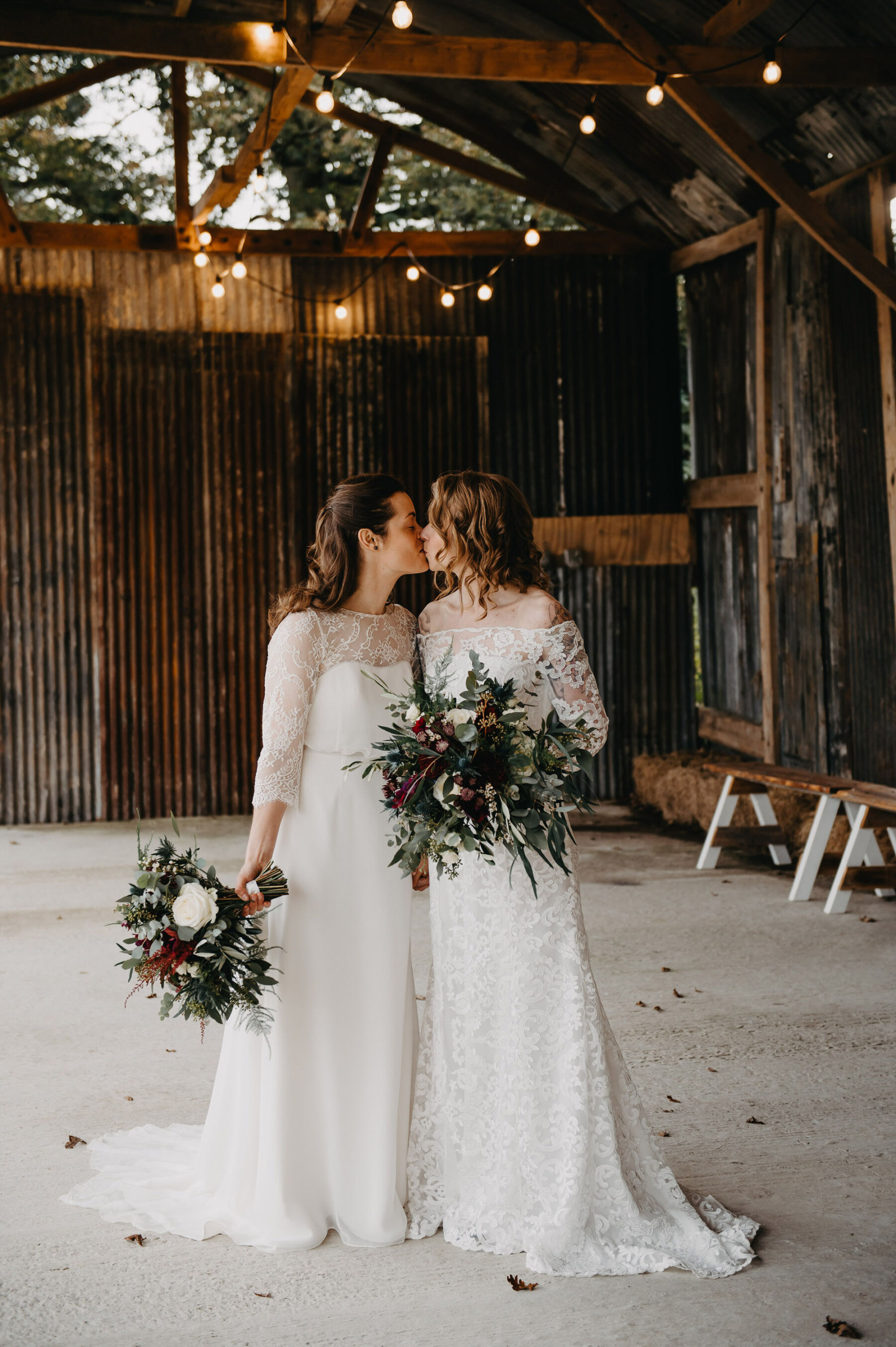 Two brides with large winter wedding bouquets at barn wedding. Jessica Grace Photography.