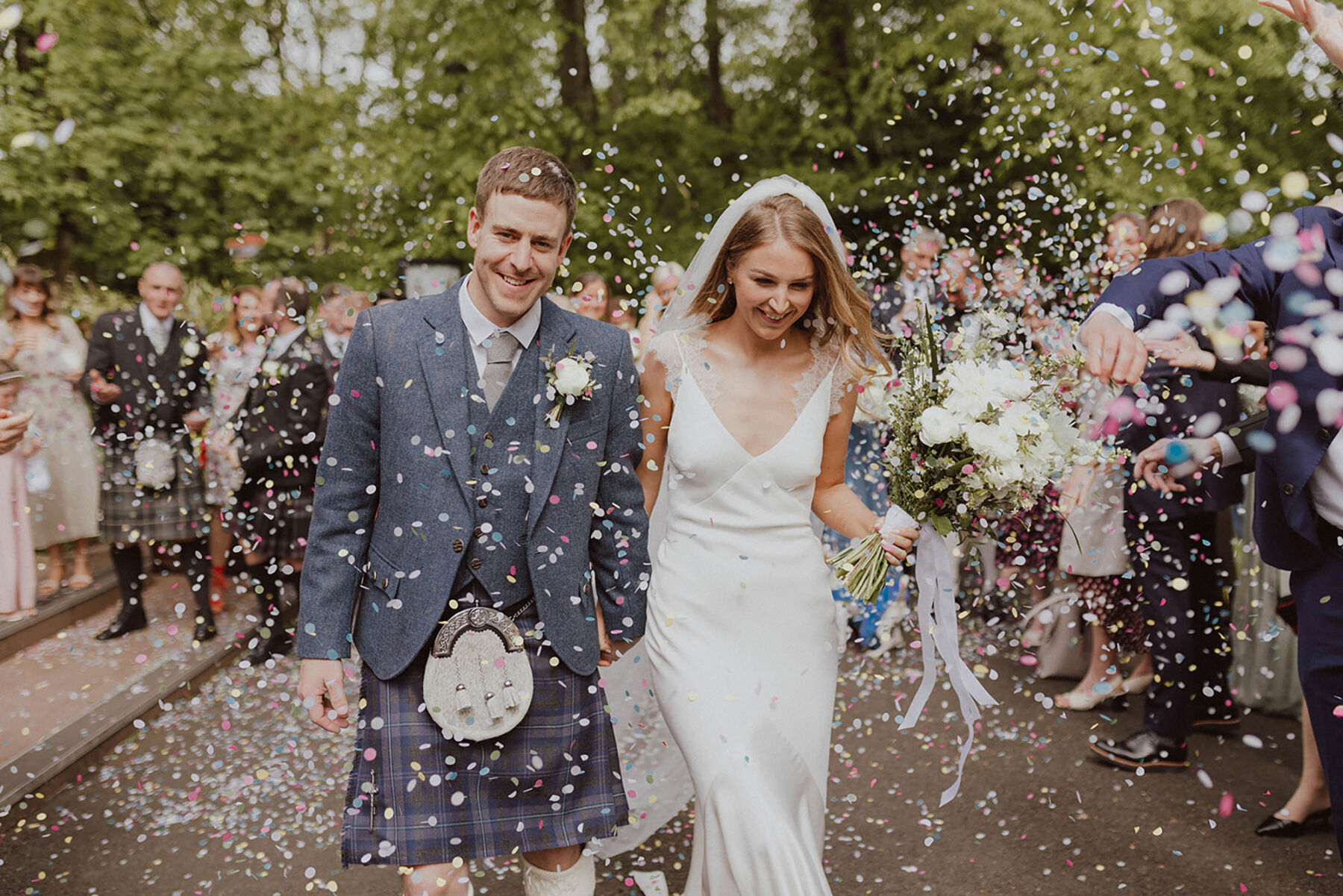 Confetti shot. Bride wearing Savannah Miller wedding dress. All white wedding bouquet.