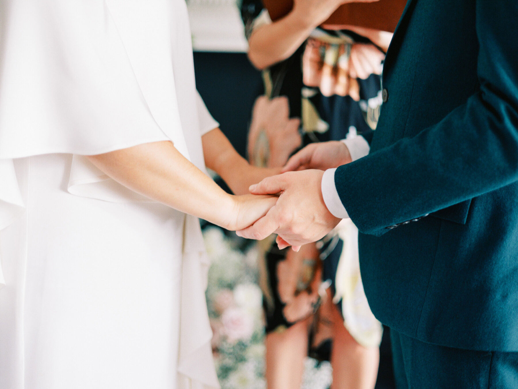Bride & groom holding hands during ceremony