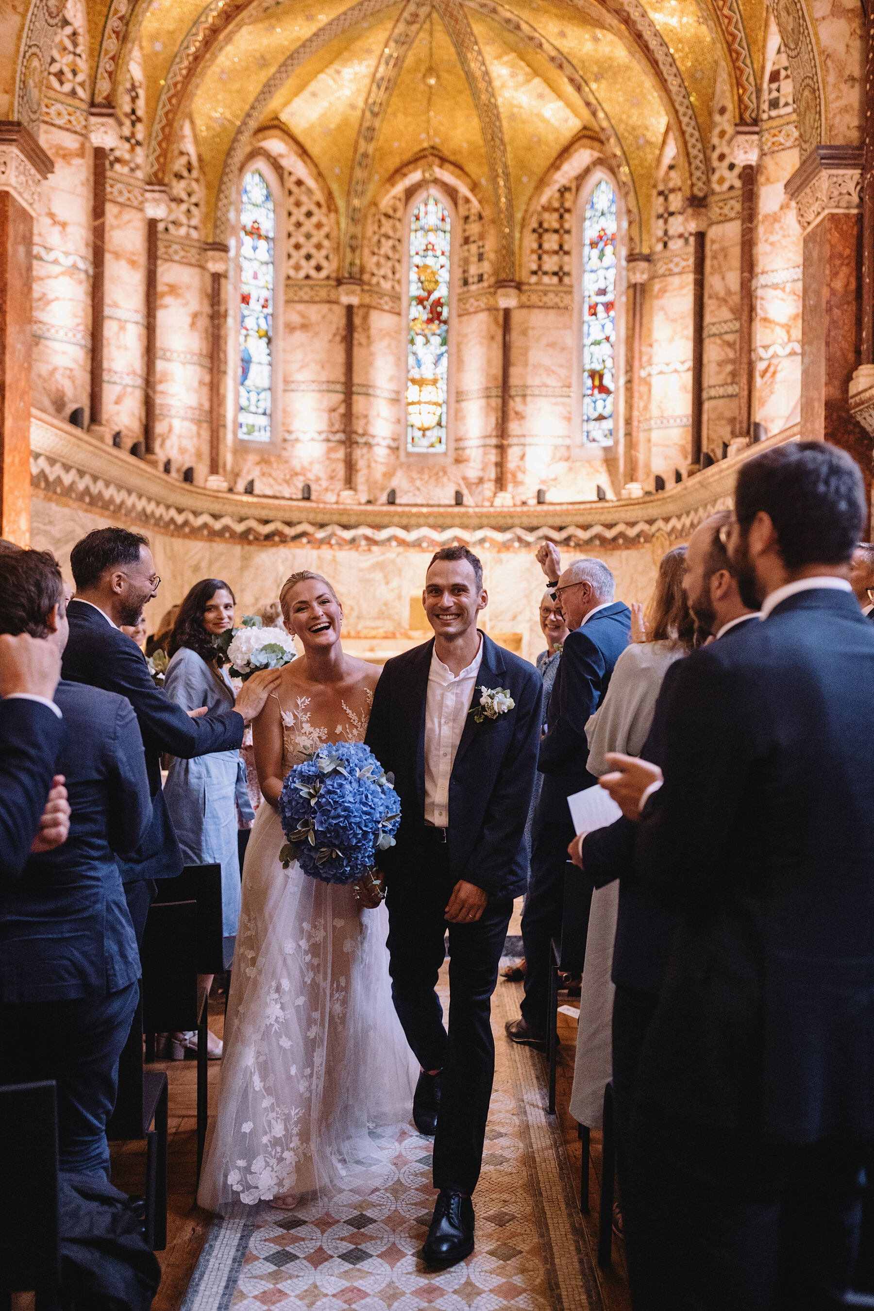 Fitzrovia Chapel London wedding. Bride in Anna Kara wedding dress + blue hydrangea bouquet. Wolf & Co. Photography.