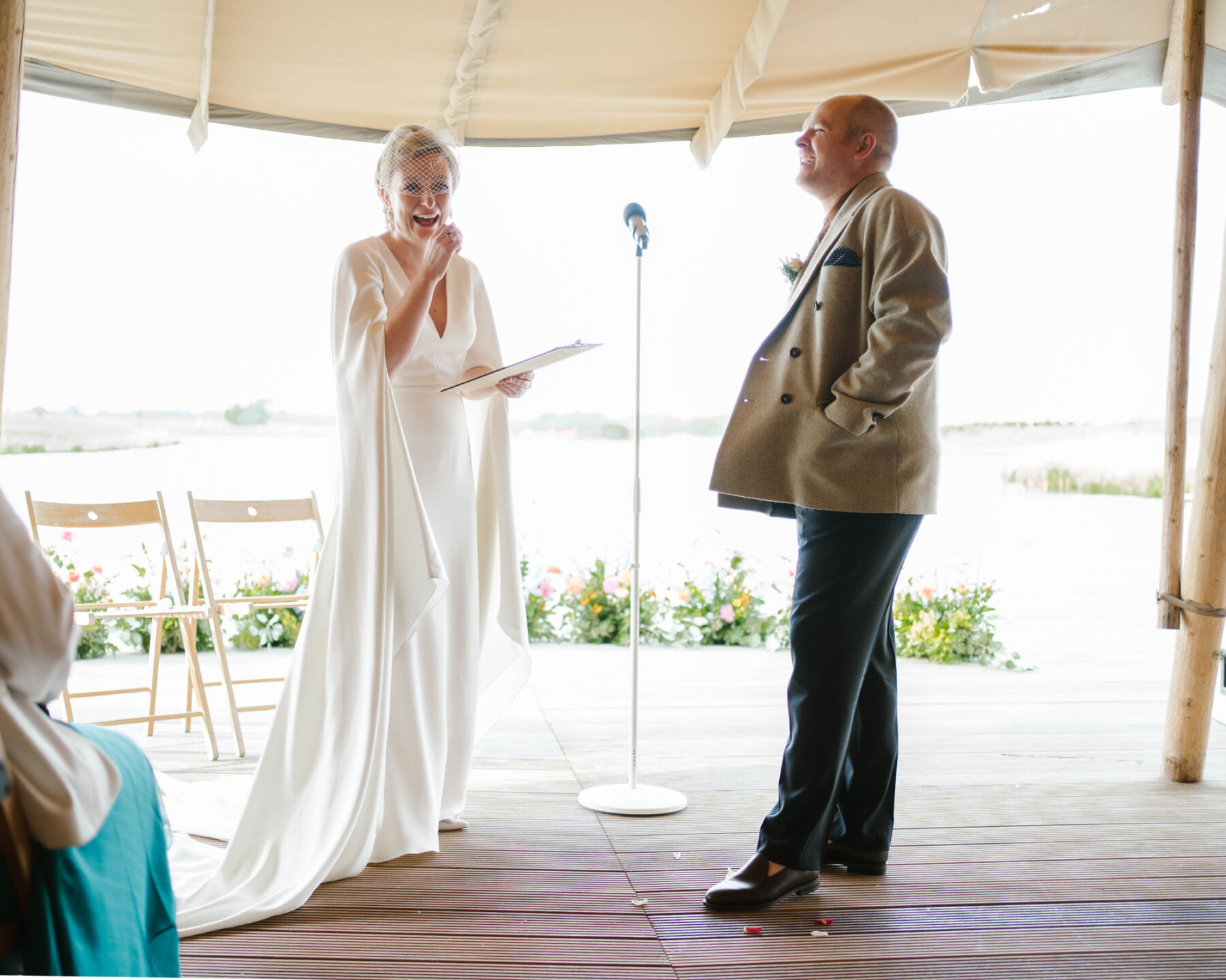 Bride laughing whilst exchanging vows