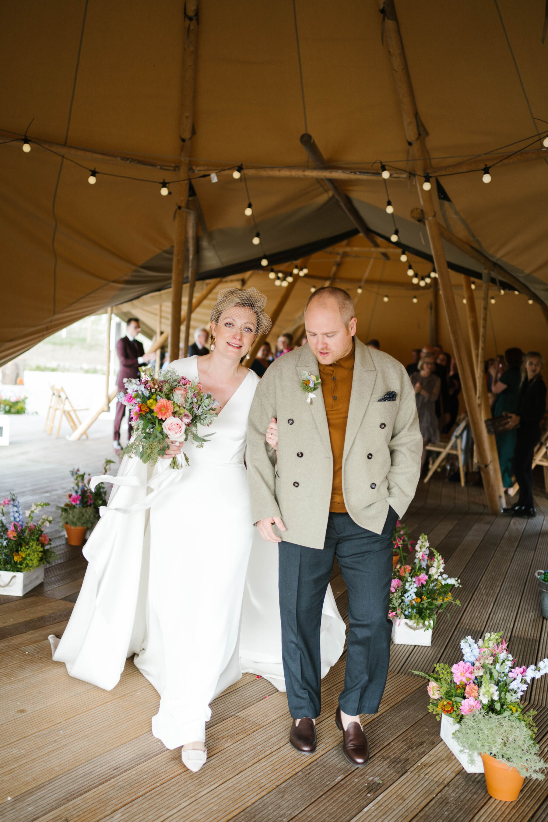 Teepee wedding at Wilderness Reserve Suffolk. Bride wears Andrea Hawkes.