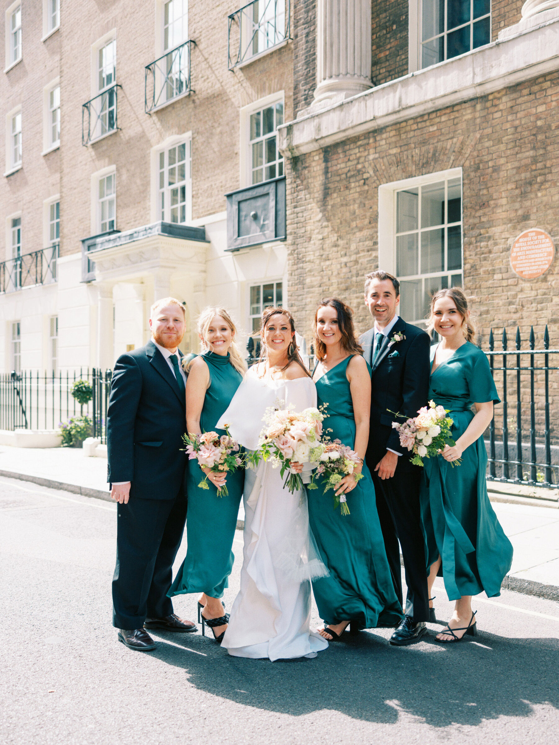 Bridesmaids in emerald green dresses by The Own Studio