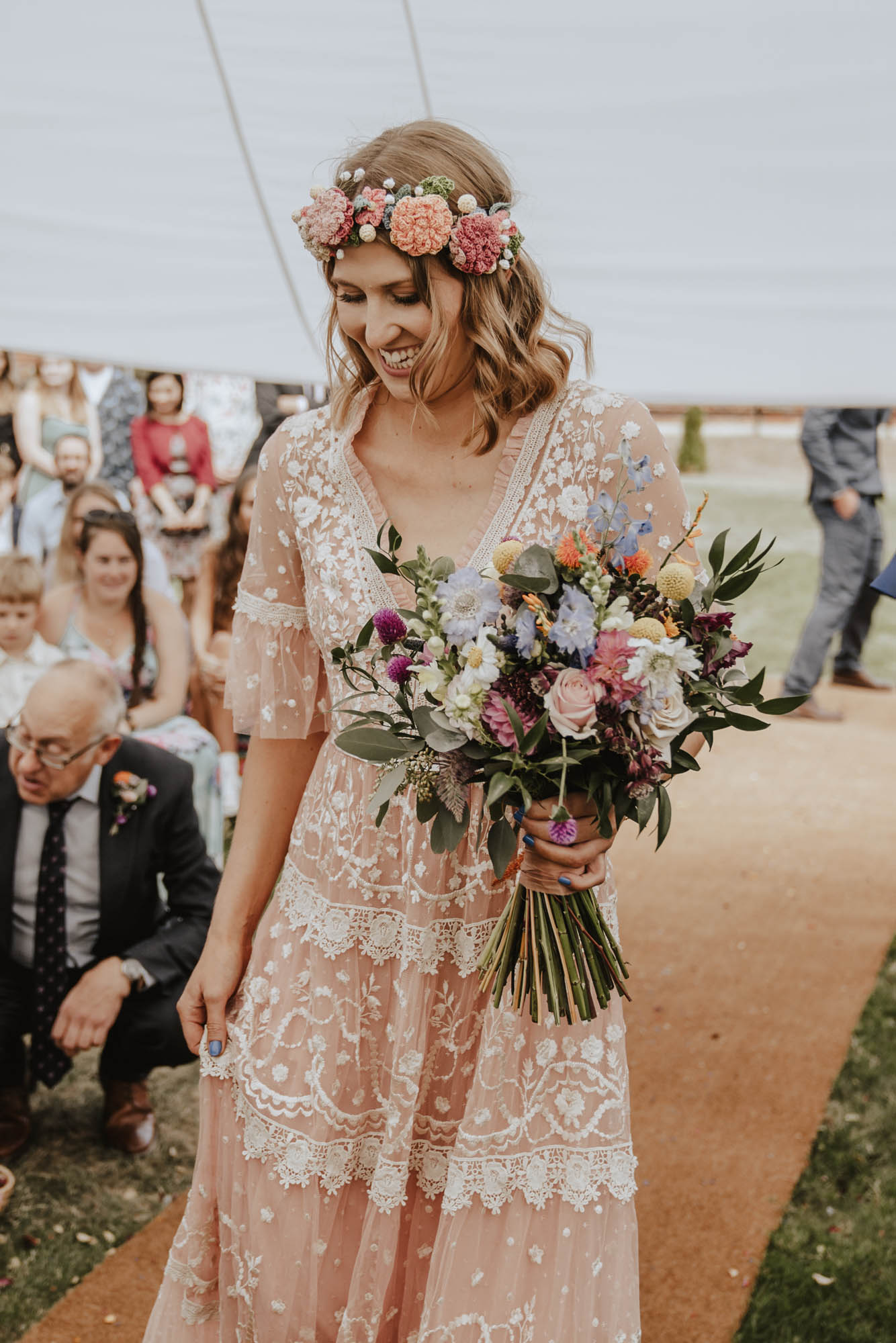 Pink wedding dress by Needle & Thread London. Colourful wedding bouquet. Crochet floral crown.