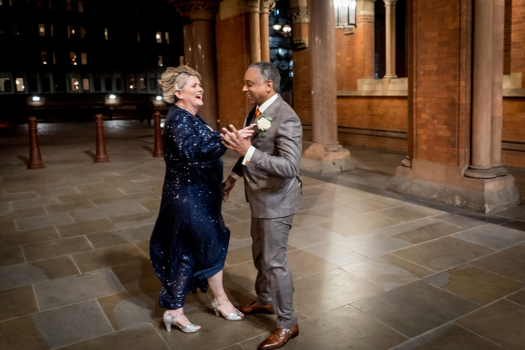 Bride in blue sequin dress dancing with groom