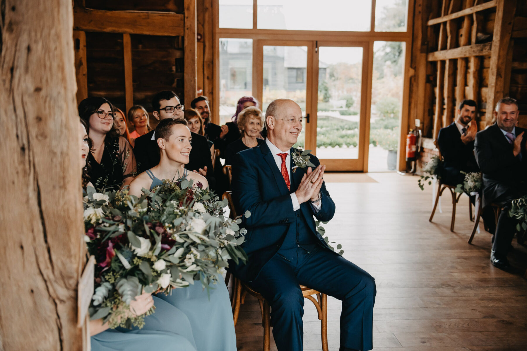 Happy father of the bride sitting during wedding ceremony. Jessica Grace Photography.