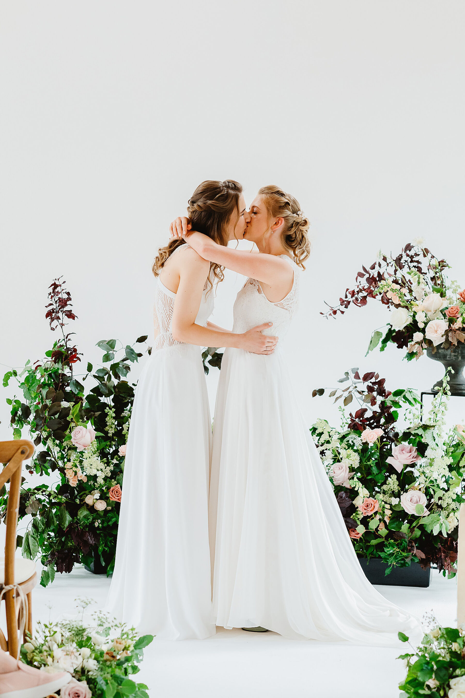 Two brides kissing