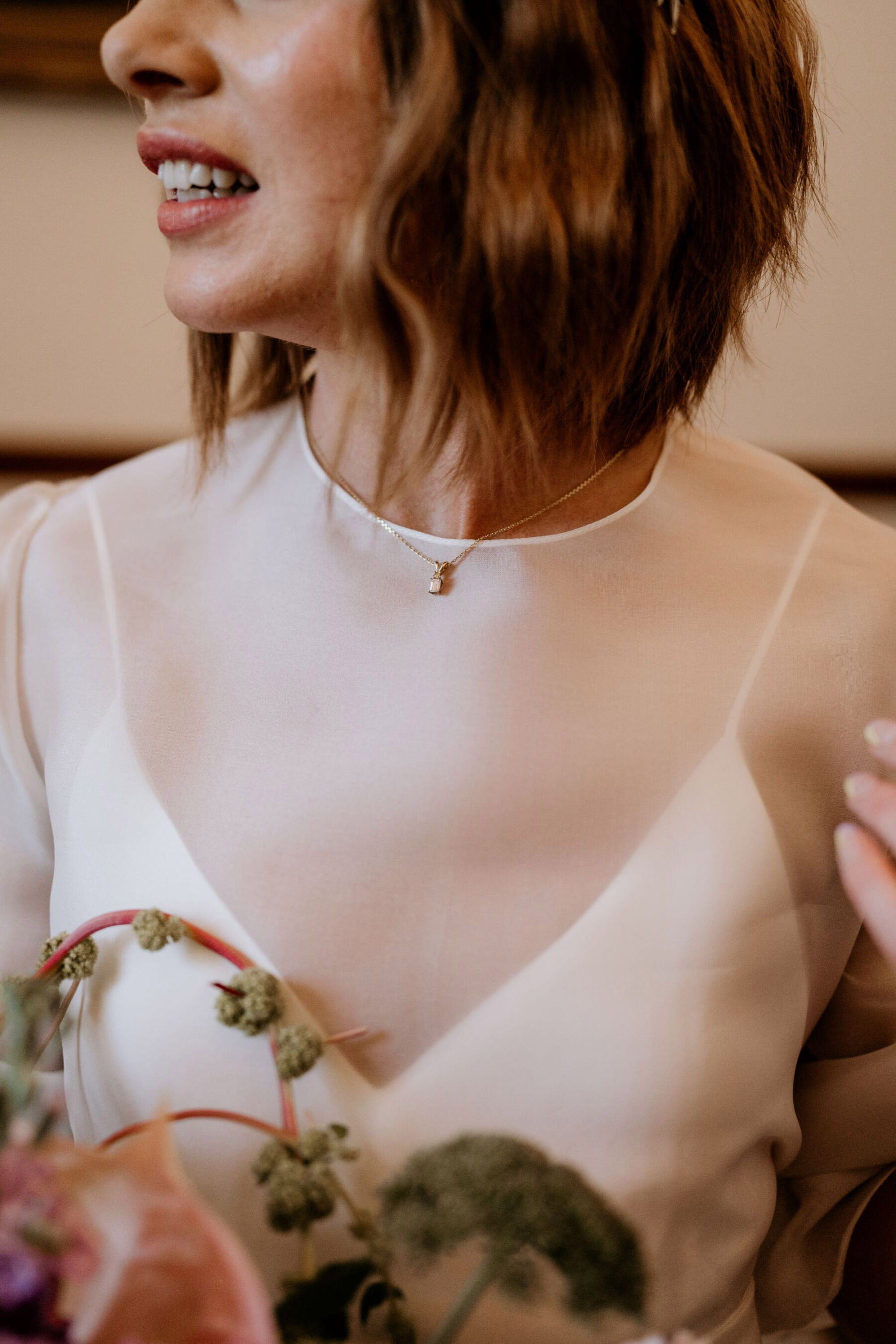 Bride wearing delicate necklace.