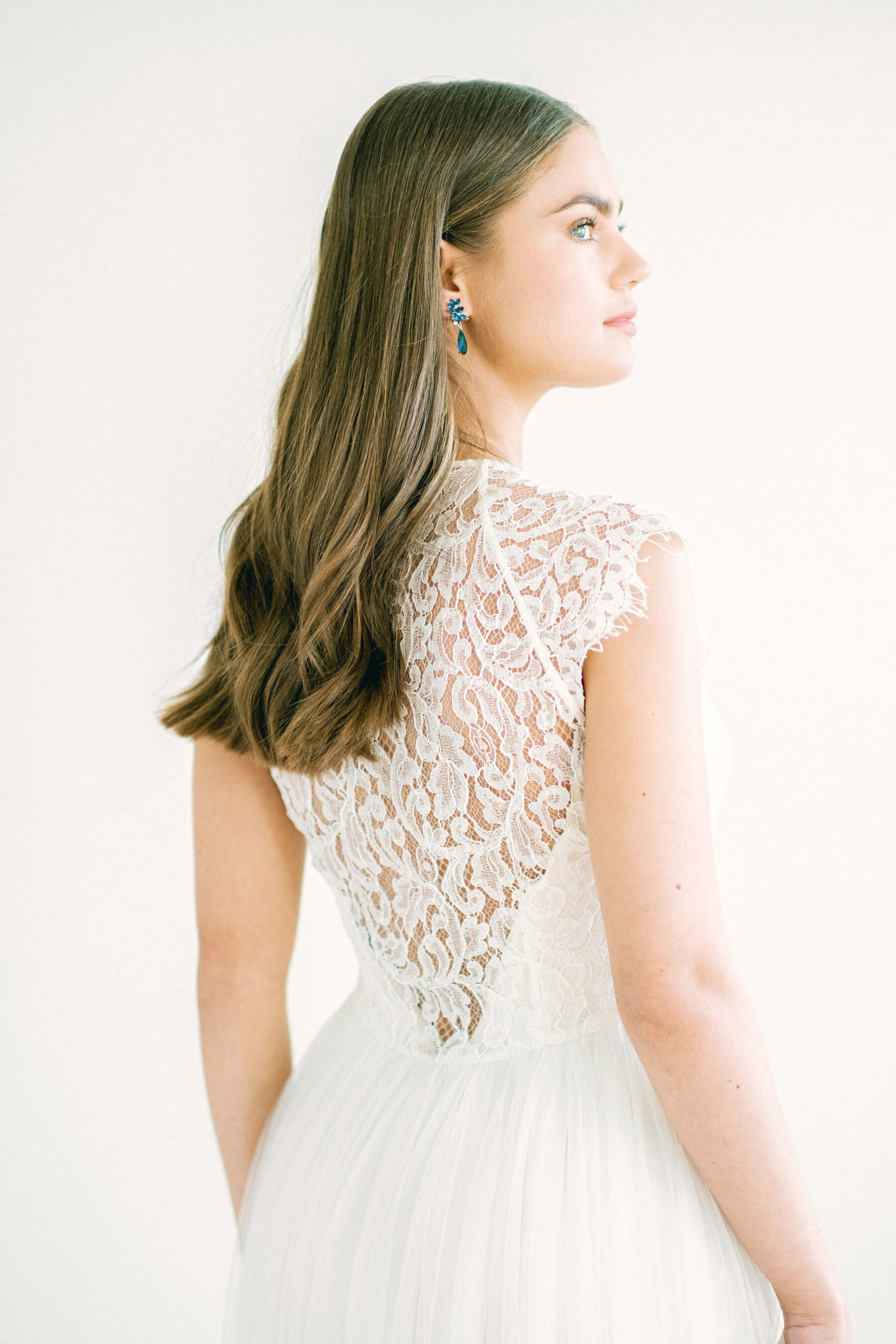 Bride wearing a Kate Beaumont ethical wedding dress with a lace panel at the back.