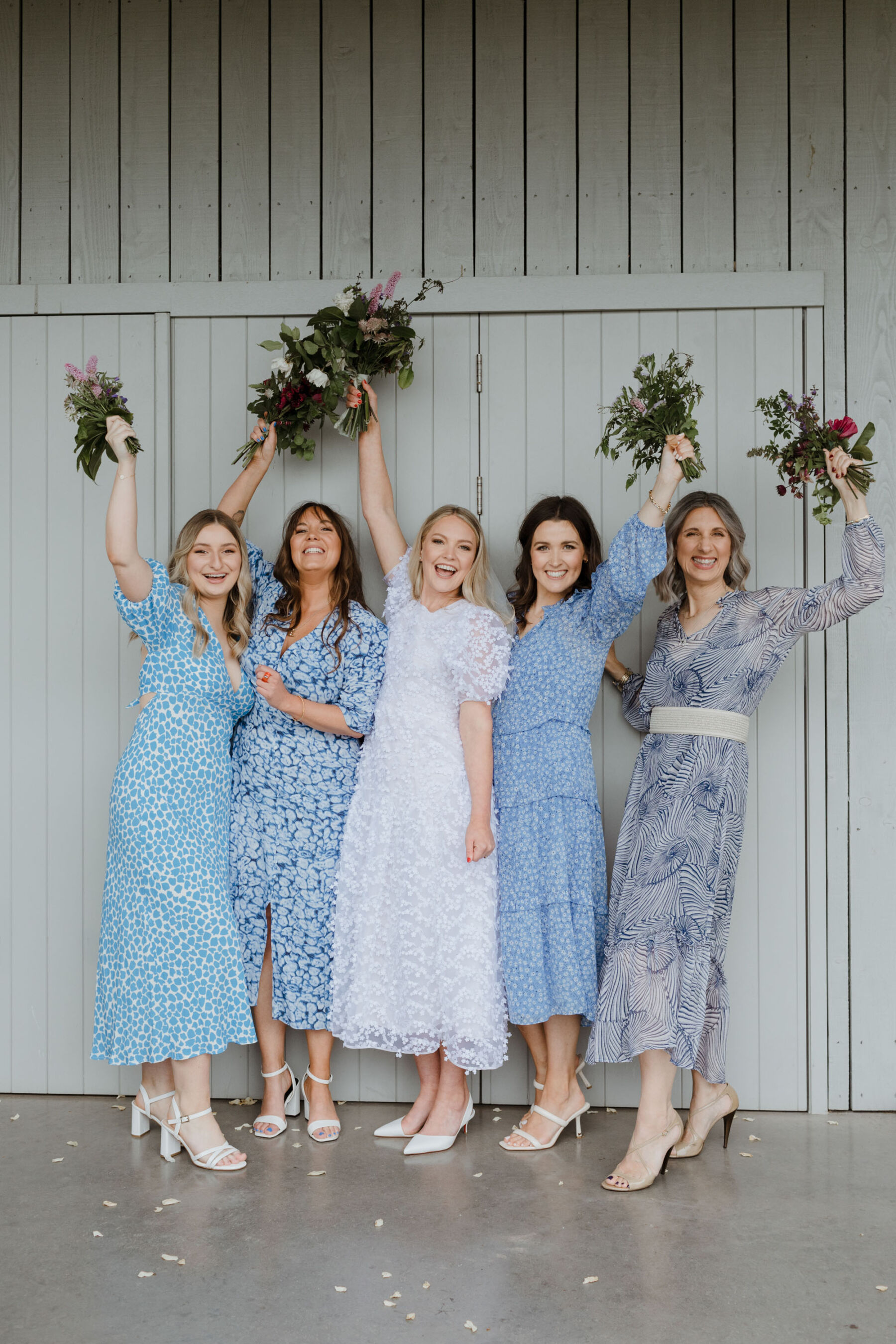 Bride in Cecilie Bahnsen & bridesmaids in pale blue floral dresses. Guardswell Farm wedding. Caro Weiss Photography.