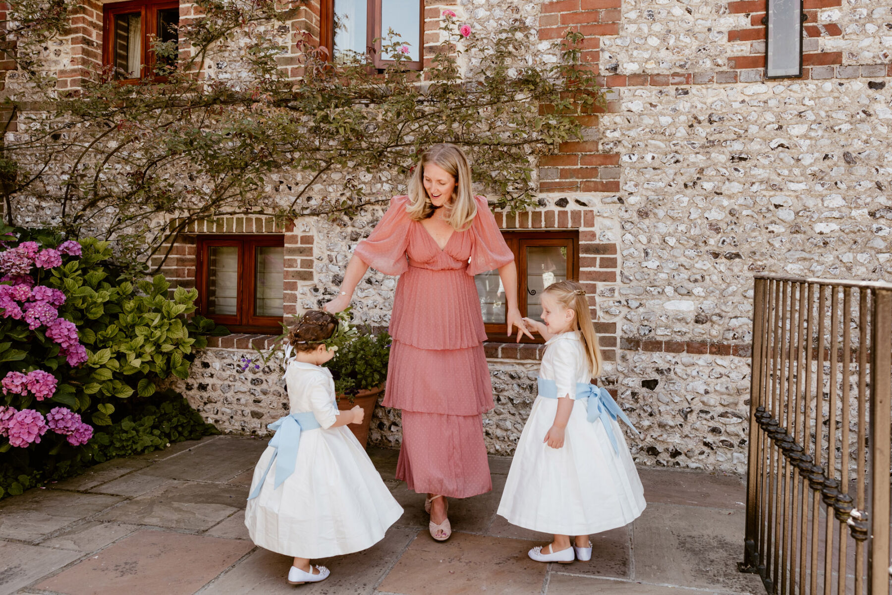 Pink puff sleeve wedding guest dress + flowergirls in traditional dresses