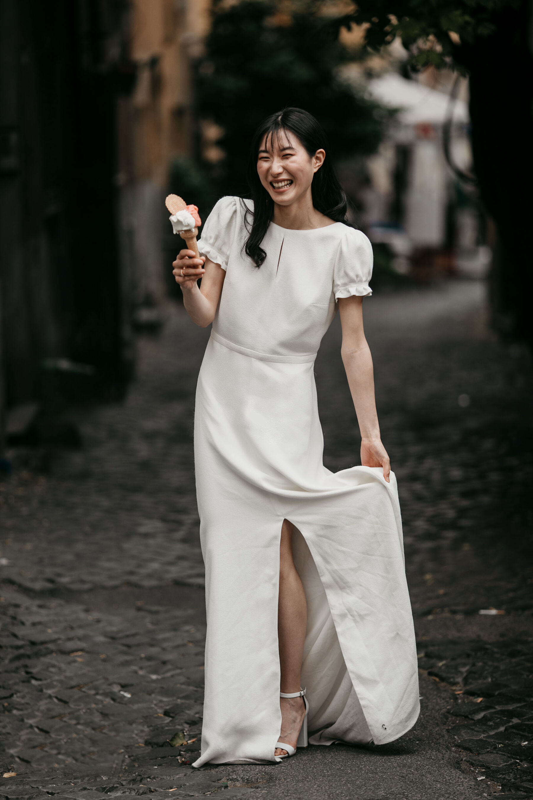 Bride eating icecream in Laure de Sagazan dress in Rome