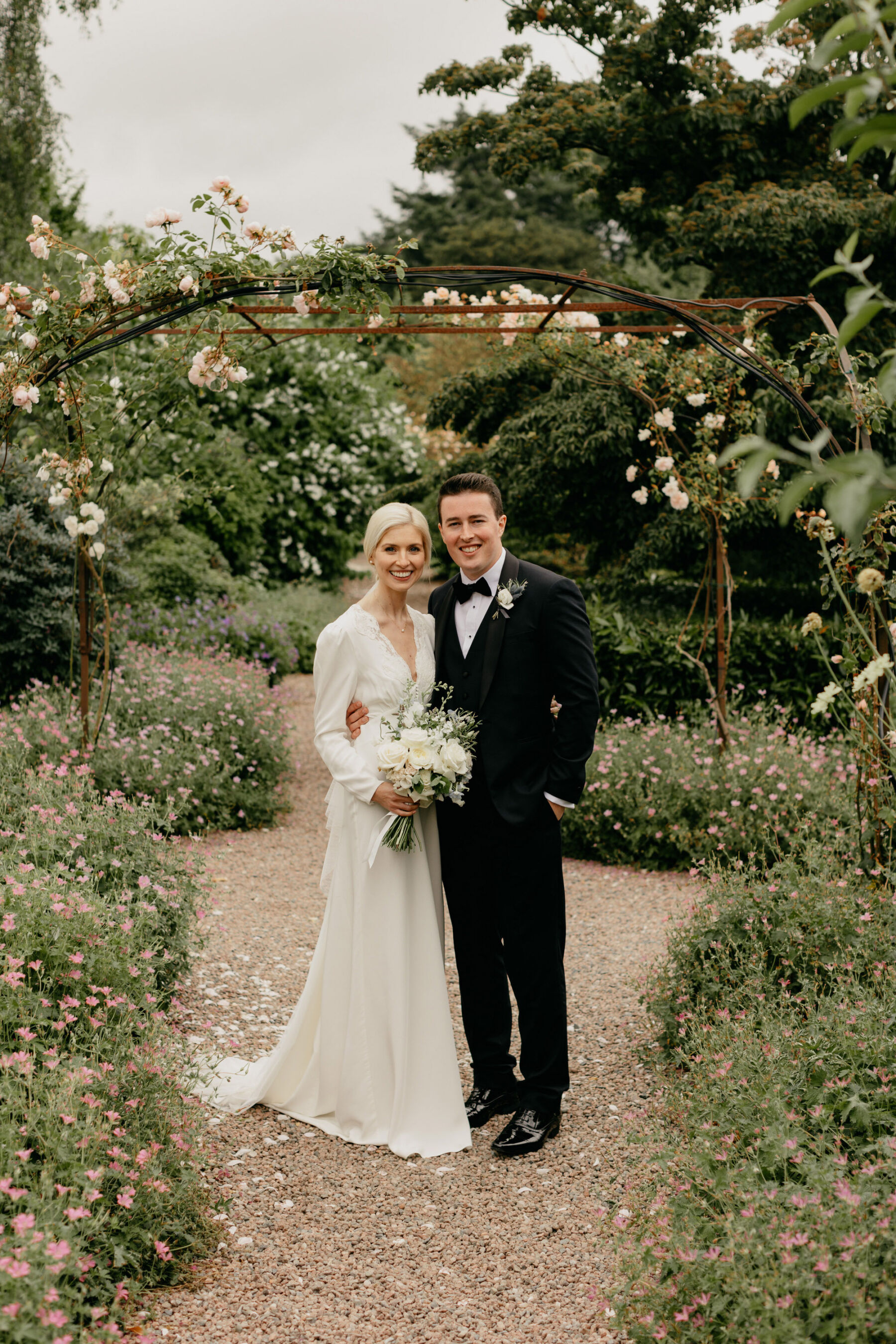 Bride wears a Rixo wedding dress for her black tie wedding at Larchfield Estate, County Down, Northern Ireland