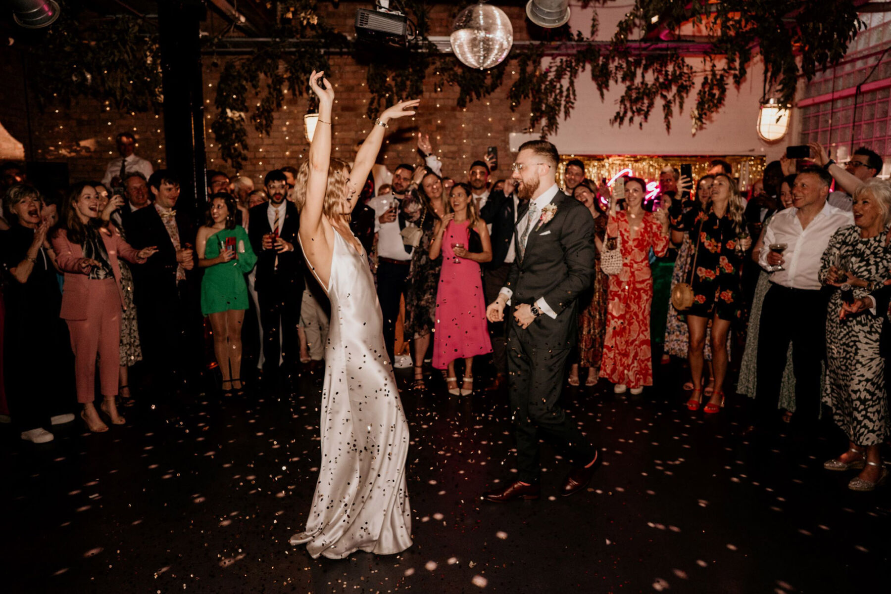 Bride wearing The Own Studio wedding dress. Wedding danceflloor with disco ball.