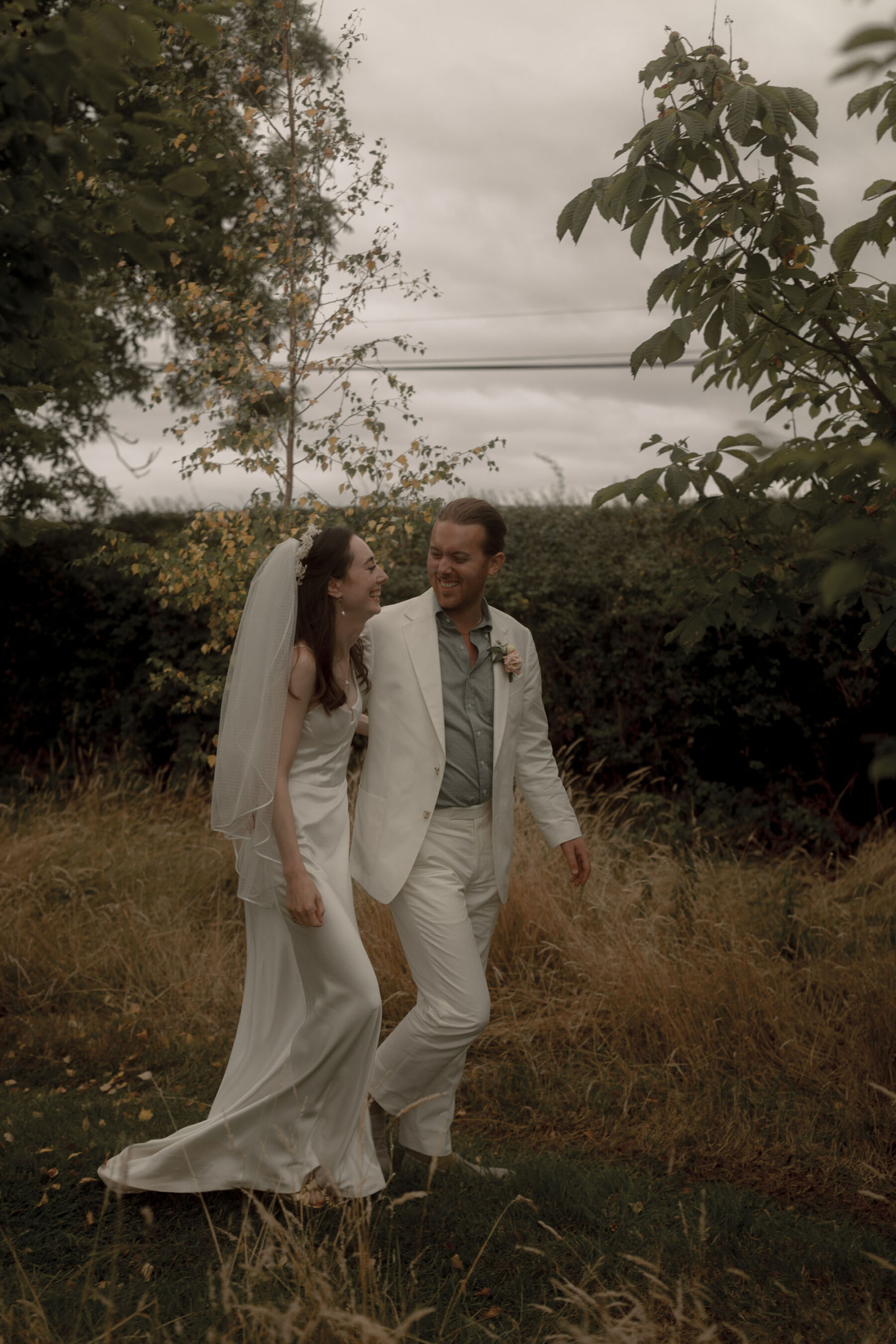 Galvan London wedding dress. Groom in white suit. Scarlet Hall wedding venue Cheshire.