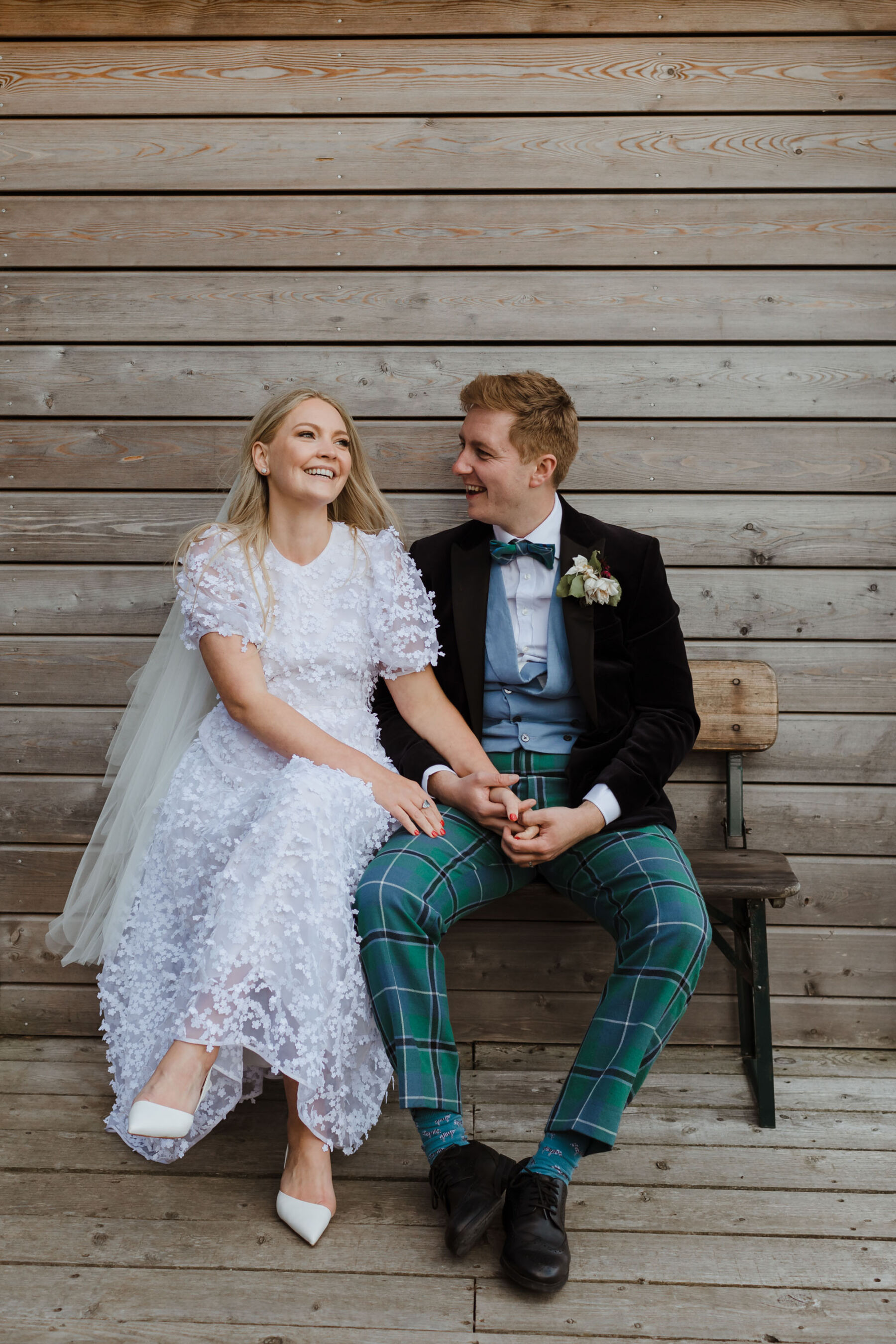 Cecilie Bahnsen wedding dress. Groom in tartan trousers. Caro Weiss Photography.