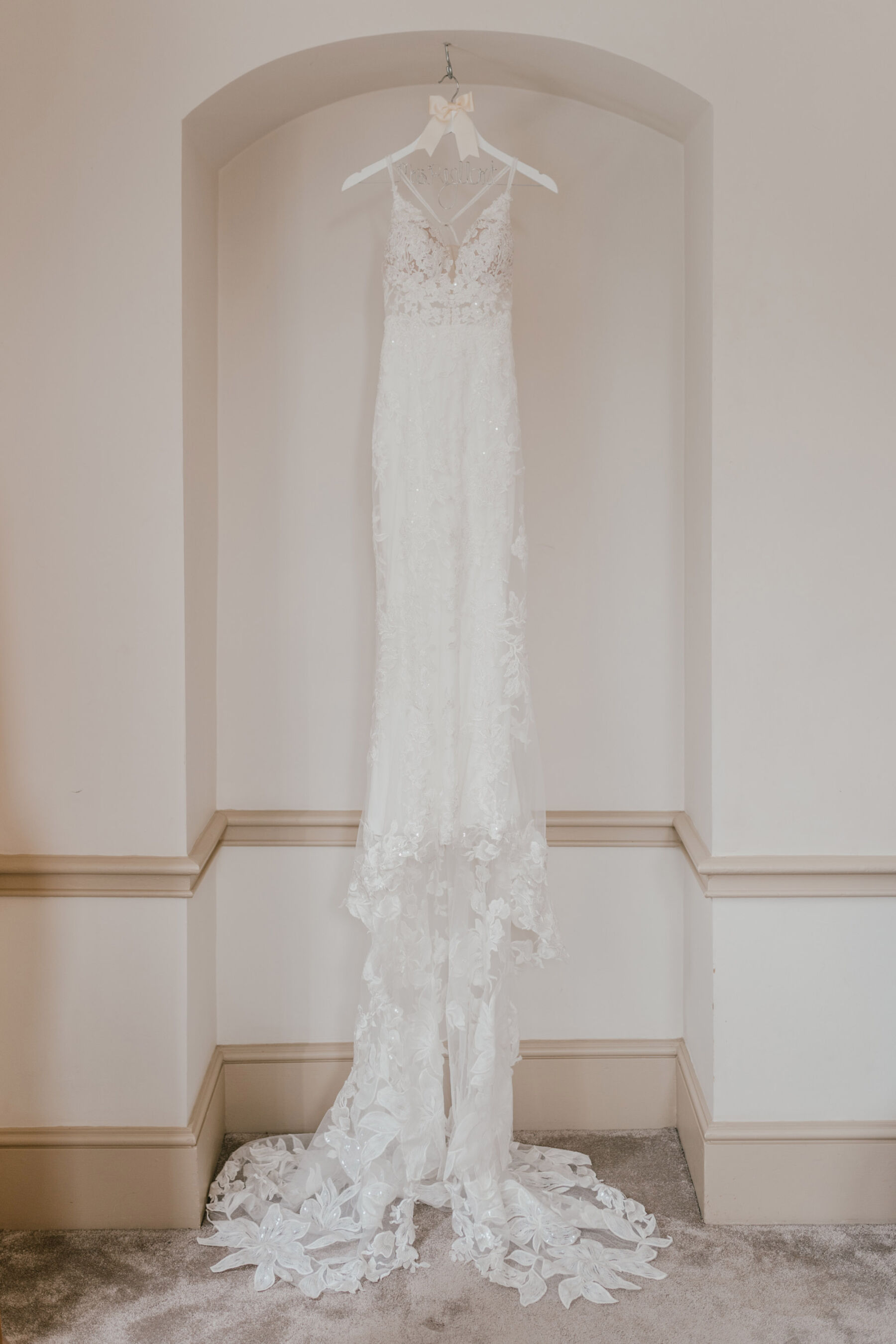 Essense of Australia wedding dress on wooden hanger at Nonsuch mansion wedding venue. Shelby Ellis Photography.