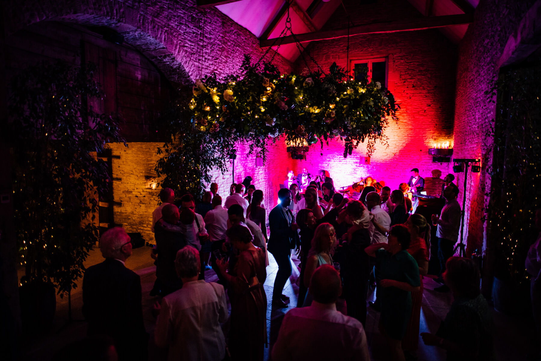Pink light flooding the wedding dancefloor.