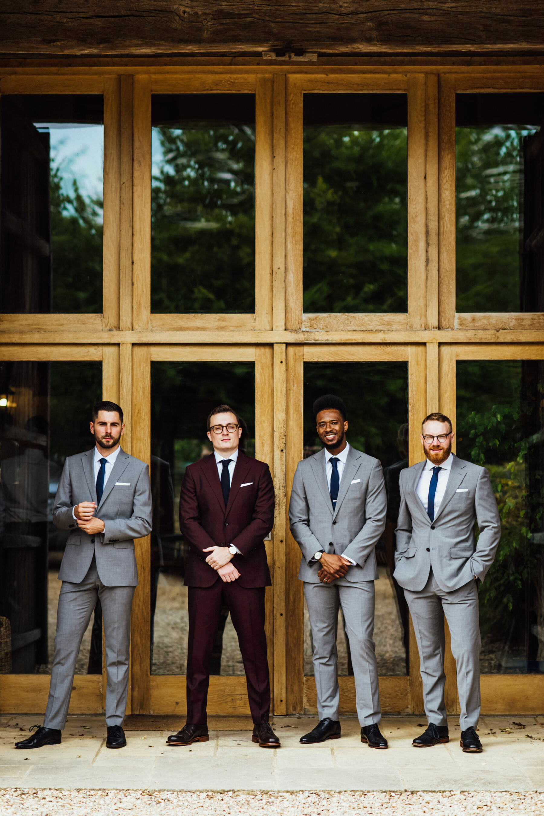 Groom in burgundy suit from Suit Supply.