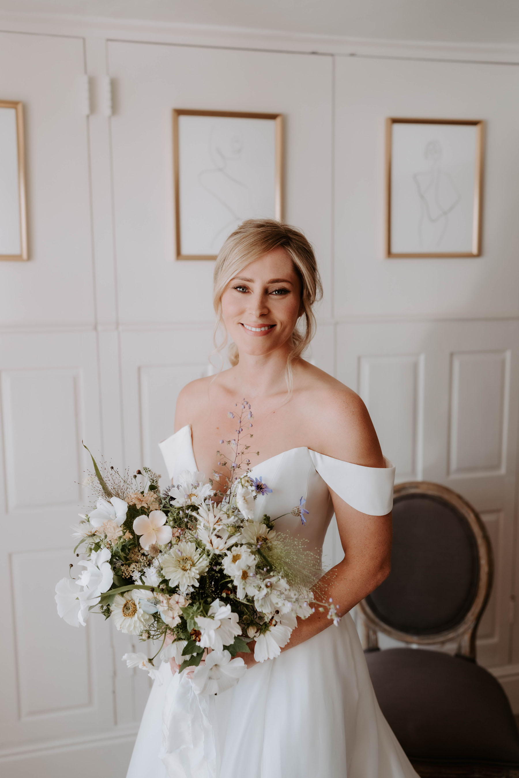 Wildflower and meadow inspired wedding bouquet. Suzanne Neville wedding dress.