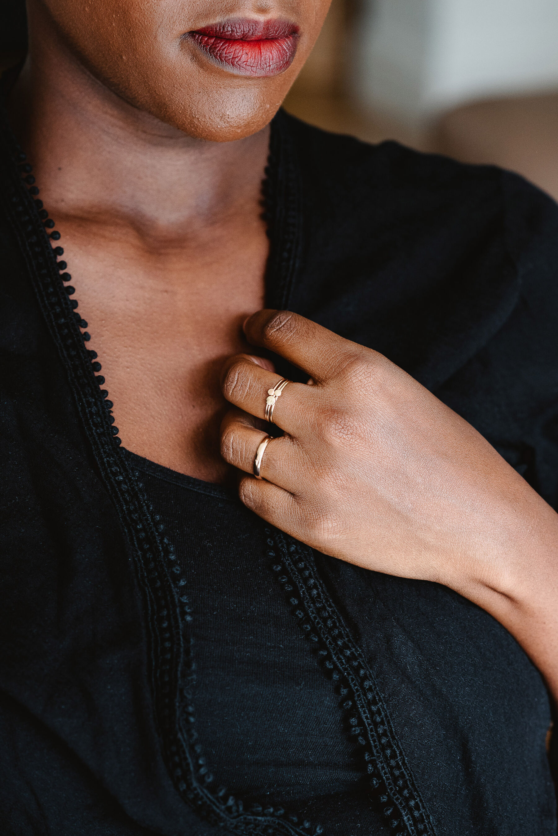 Black woman wearing ethical fairtrade gold rings by Nikki Stark Jewellery