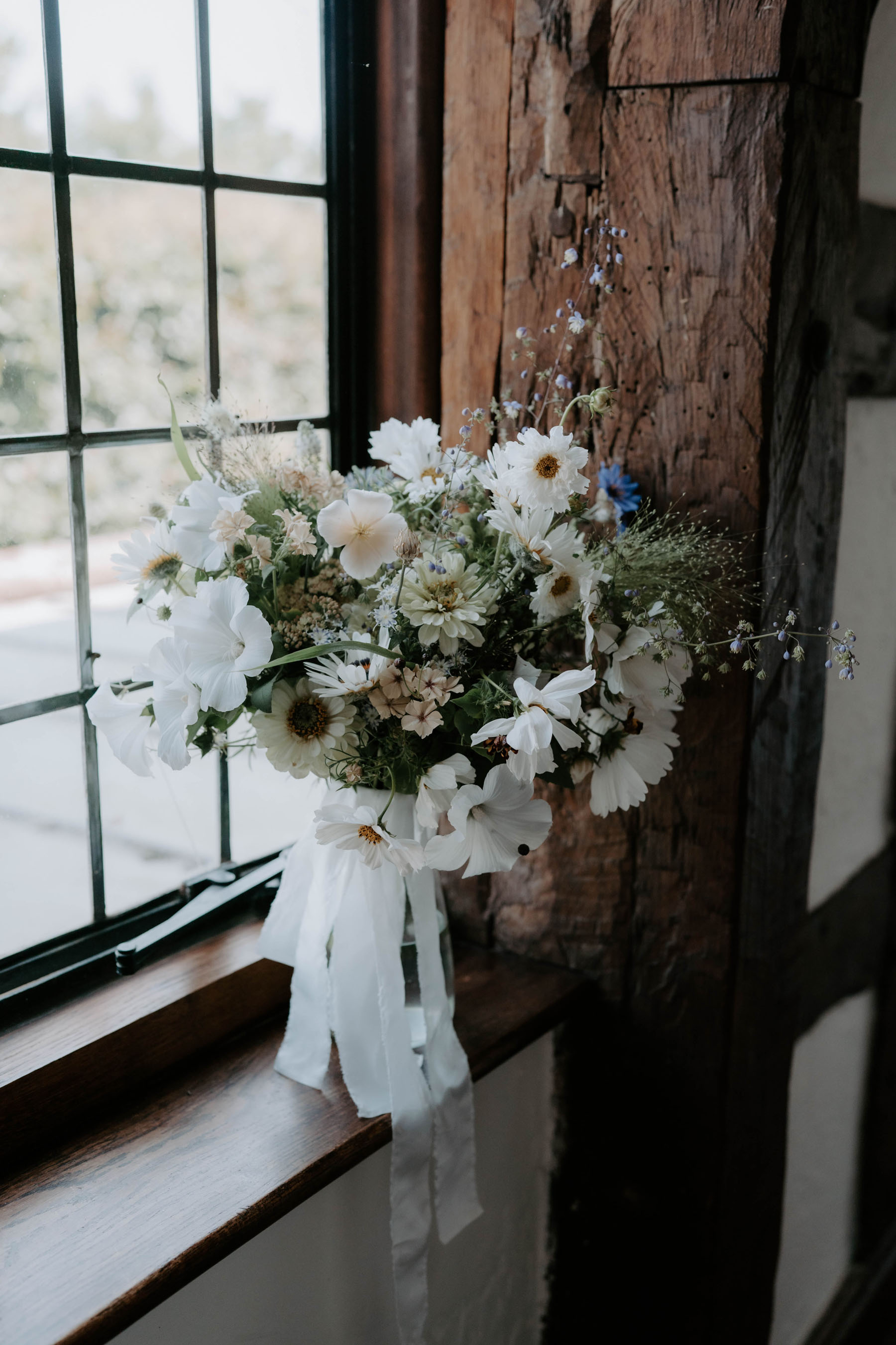Wildflower and meadow inspired wedding bouquet with cream colour silk ribbons.