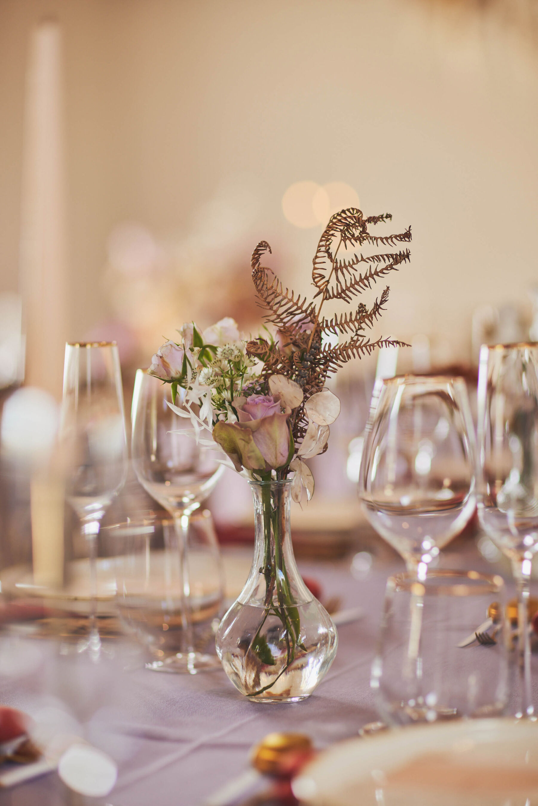 Table flowers in bud vases at Brickhouse Vineyard - Devon wedding venue.