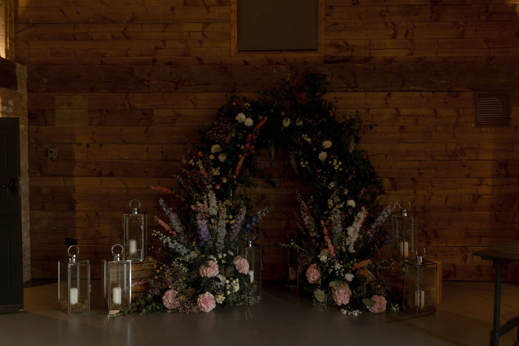 Colourful floral arch ceremony backdrop.