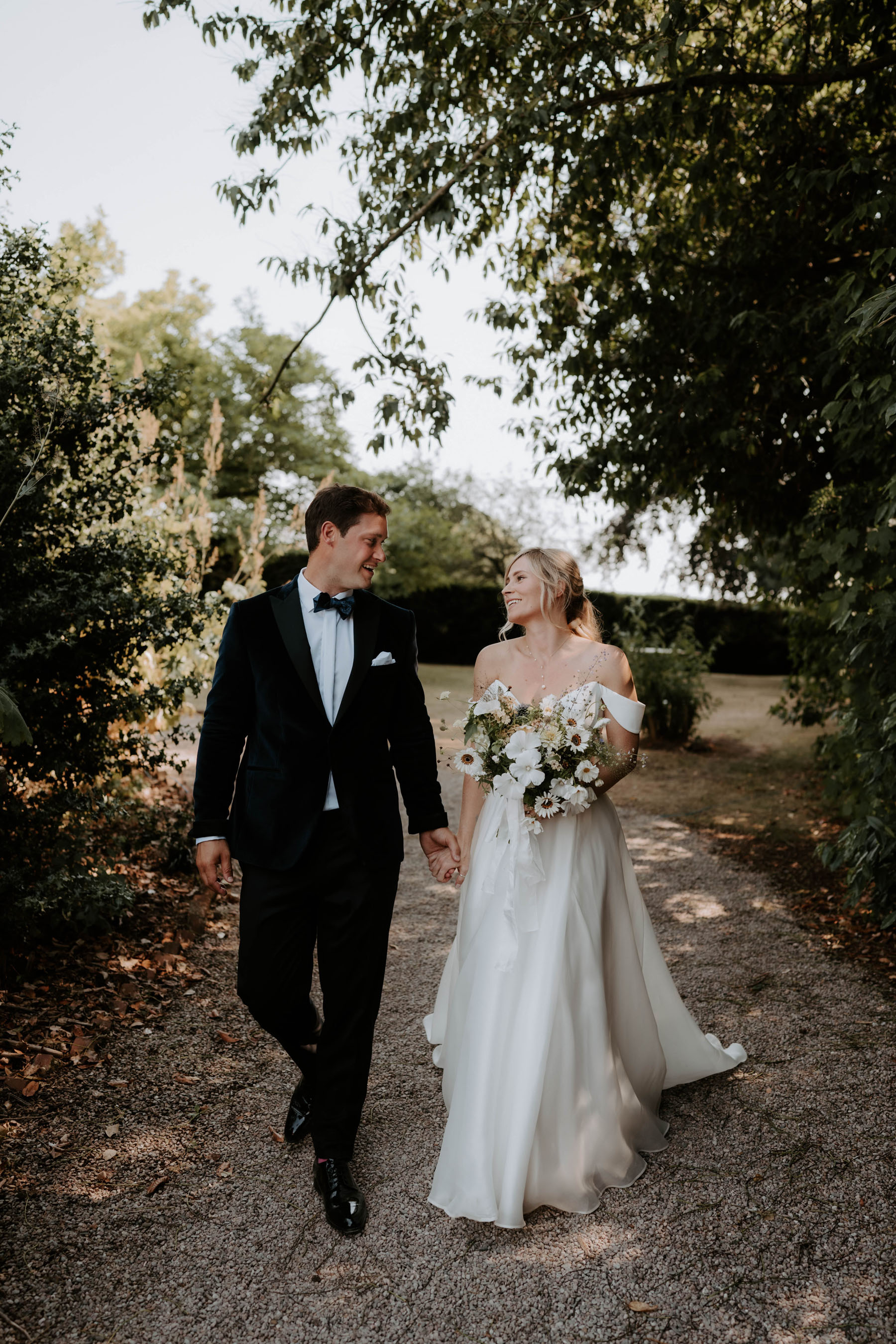 Bride wearing Suzanne Neville holding grooms hand. Broadfield wedding, country house wedding venue, Herefordshire, West Midlands.