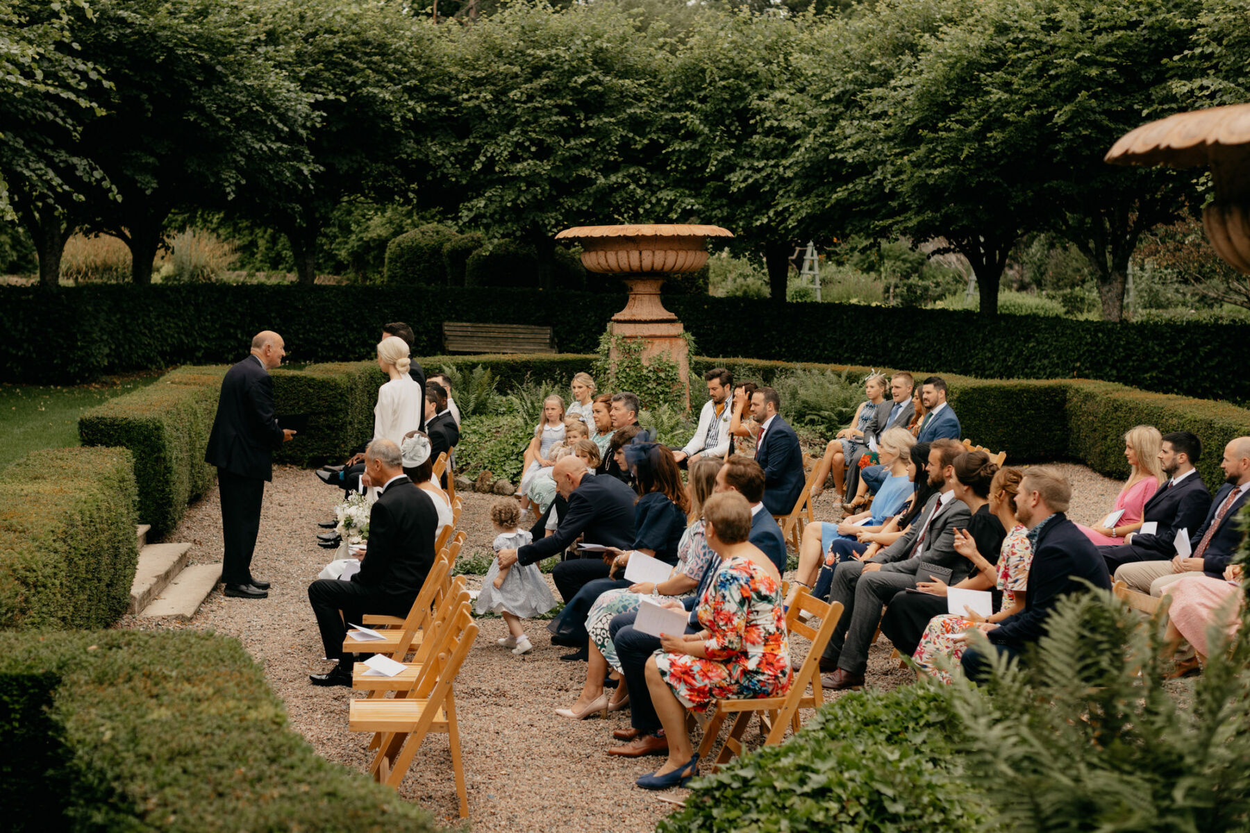Outdoor wedding ceremony with wooden chairs at Larchfield Estate.