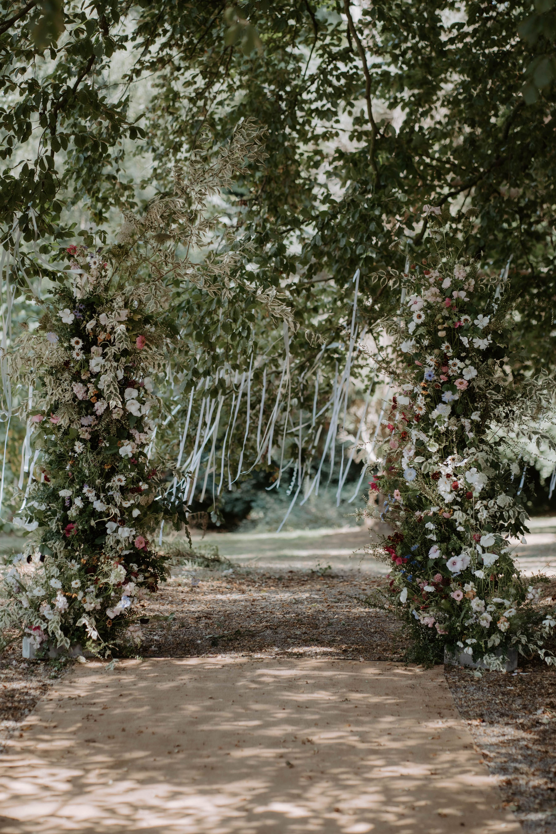 Broken floral arch for outdoor wedding ceremony at Broadfield, Herefordshire