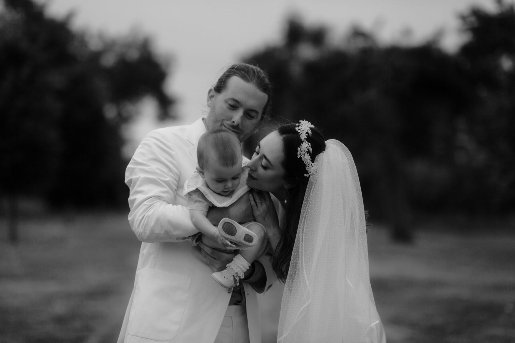 Bride & groom with their baby daughter.