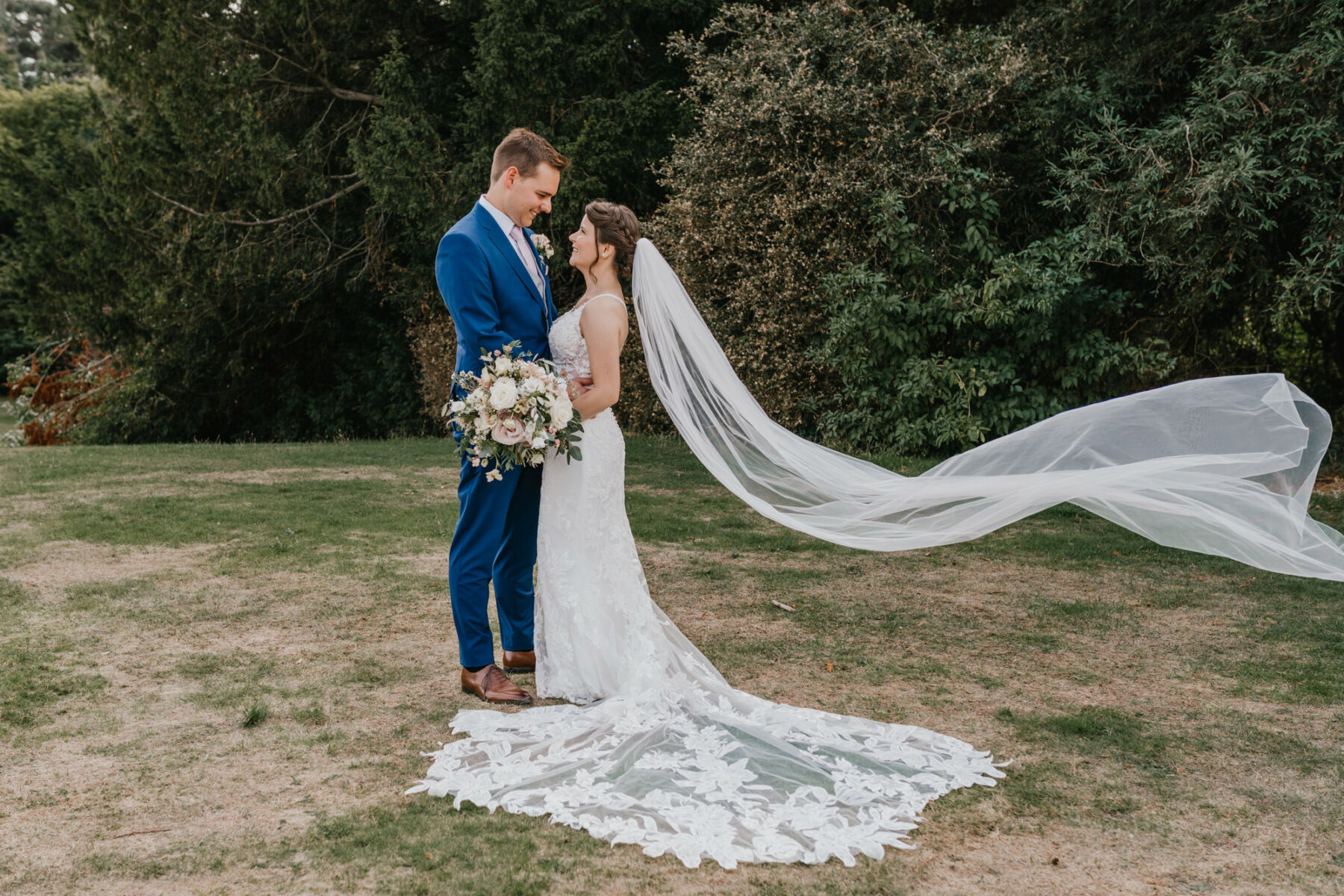 Bride wearing an Essense of Australia wedding dress and long veil flying in the breeze. Nonsuch Mansion wedding, Surrey. Shelby Ellis Photography.