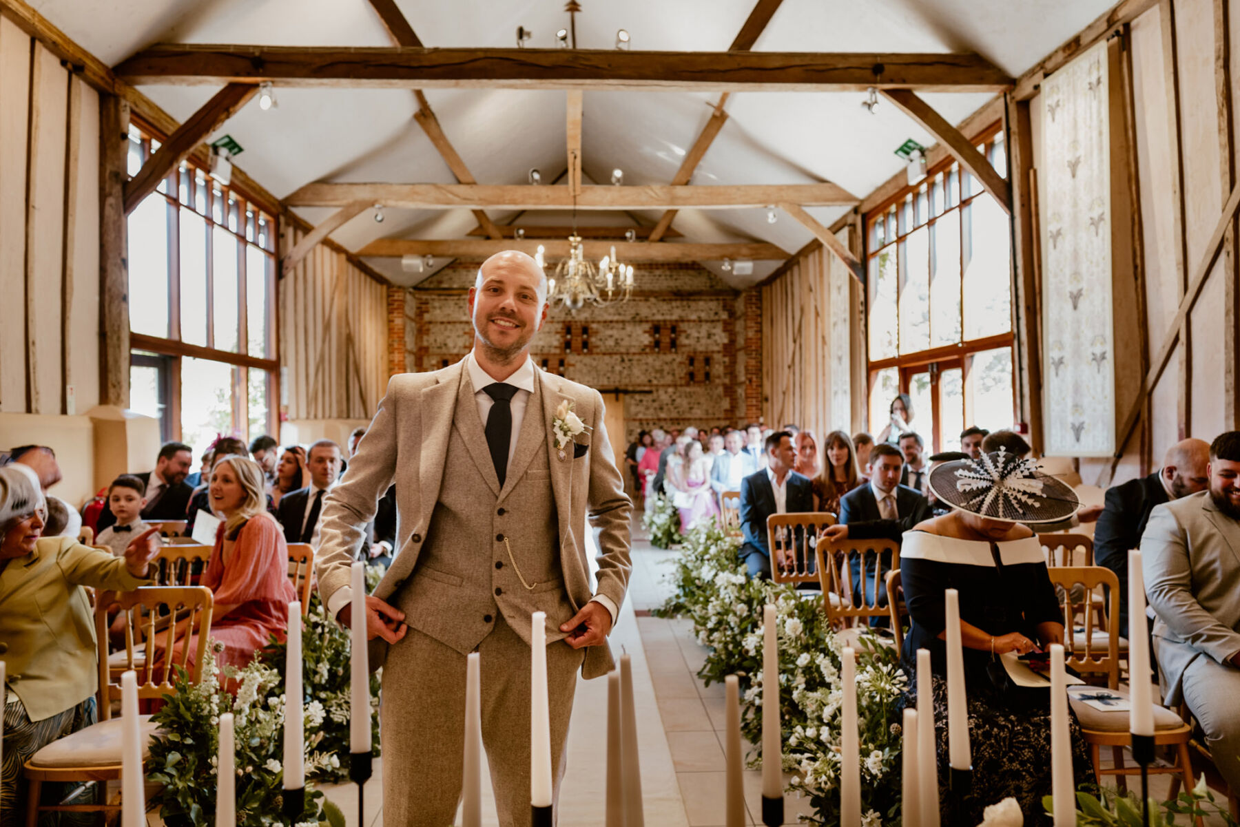 Groom in pale suit from Next. Upwaltham Barns wedding ceremony.
