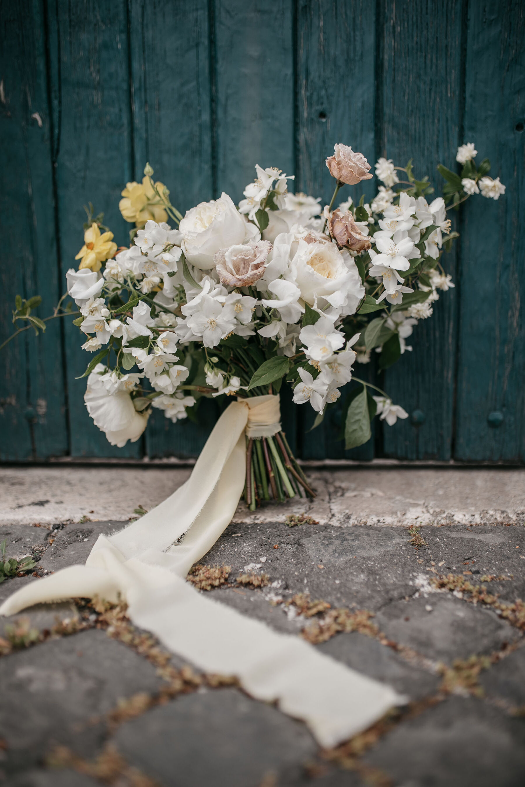 Seasonal white and yellow Spring wedding bouquet with silk ribbons