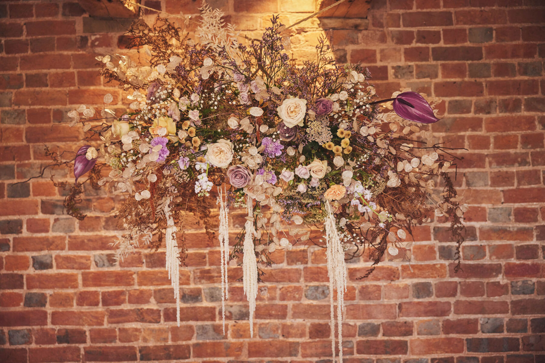 Hanging floral installations at Brickhouse Vineyard - Devon wedding venue.