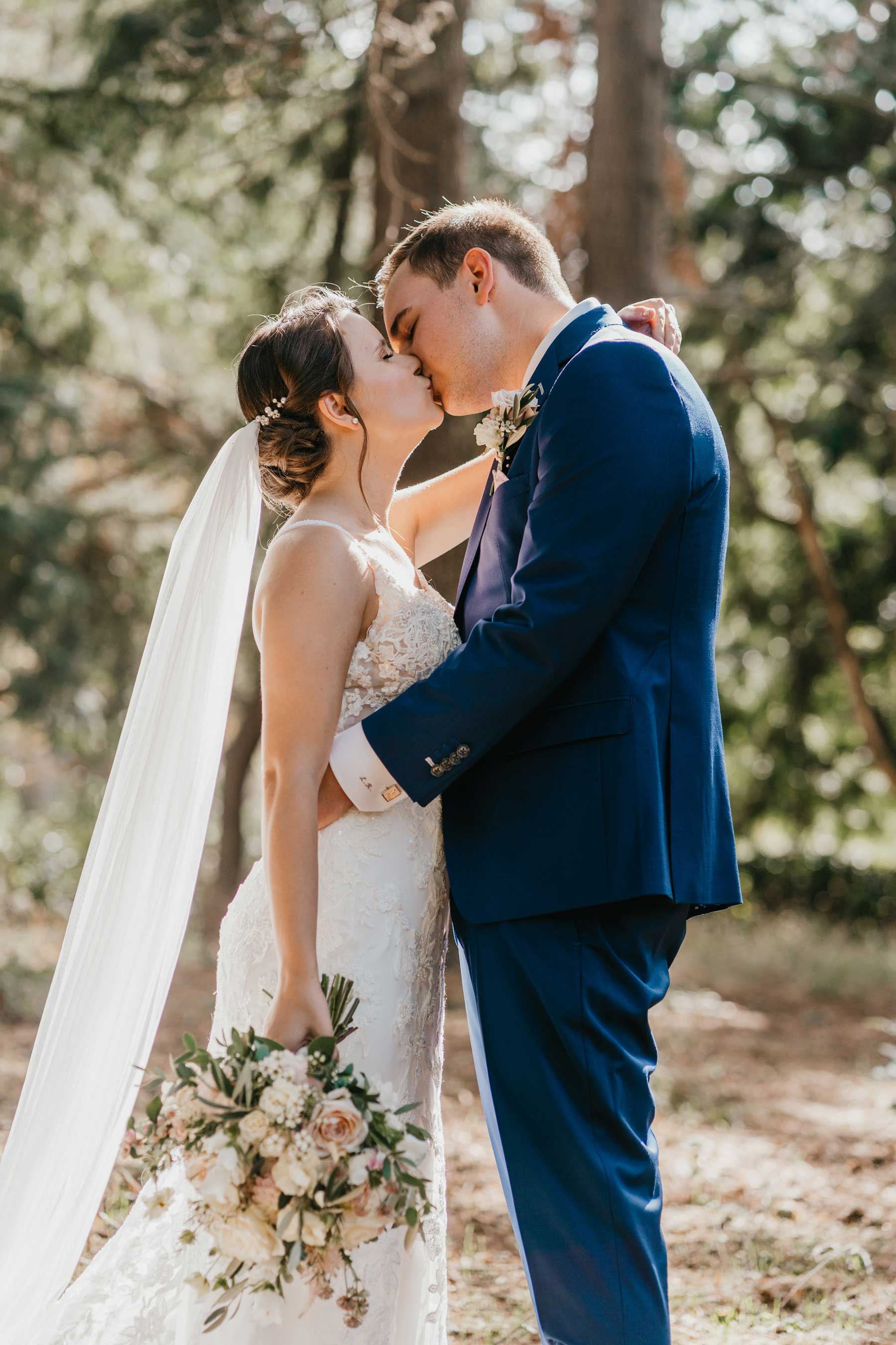 Bride & groom kissing. Bride wears Essense of Australia gown. Shelby Ellis Photography.