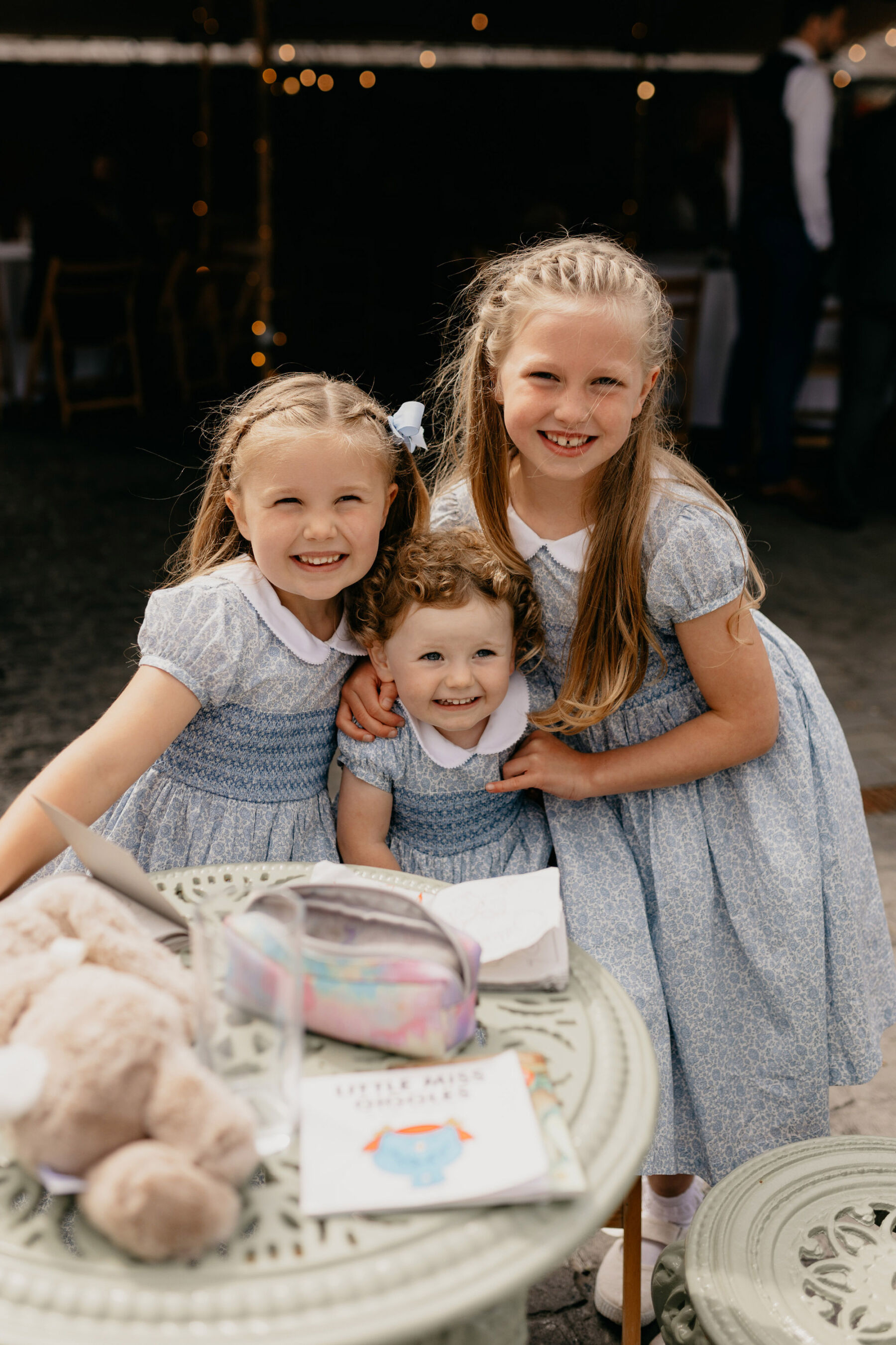Flower girls in cute pale blue Liberty print dresses with Peter Pan collar. Trotters Childrenswear.