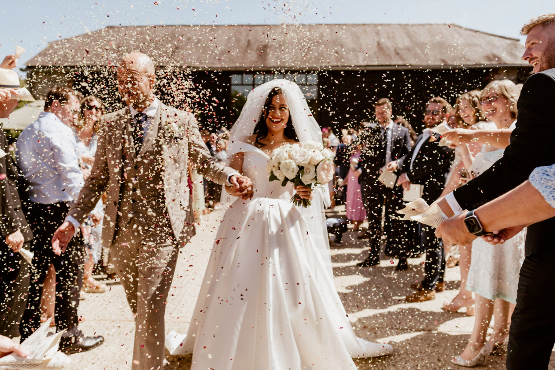 Confetti, Upwaltham Barns wedding venue, Bride wears Suzanne Neville wedding dress & veil from Miss Bush bridal boutique, Surrey, UK.