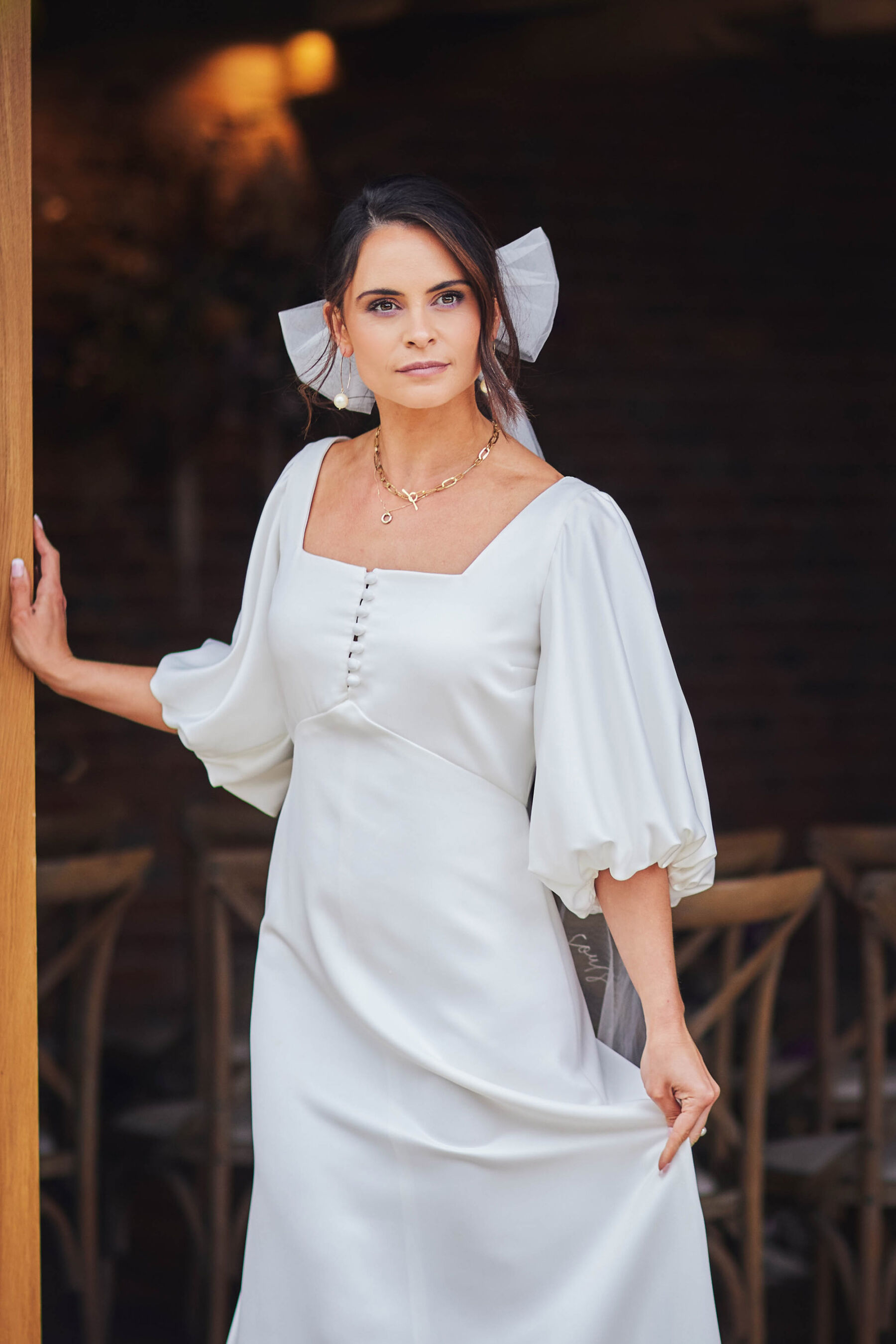 Modern bride in bow hair accessory at Brickhouse Vineyard - Devon wedding venue.