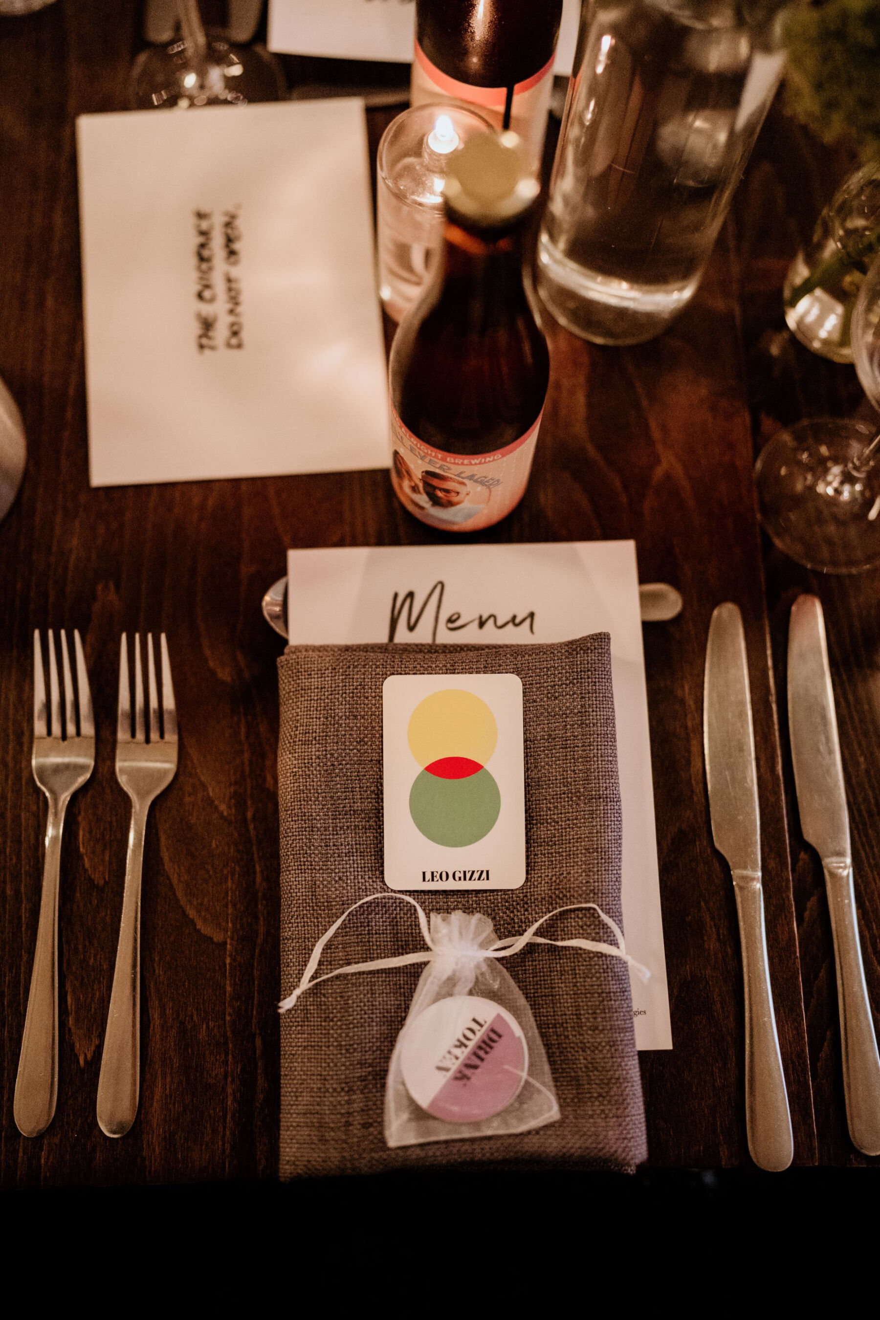 Modern wedding table place setting with geometric stationery.