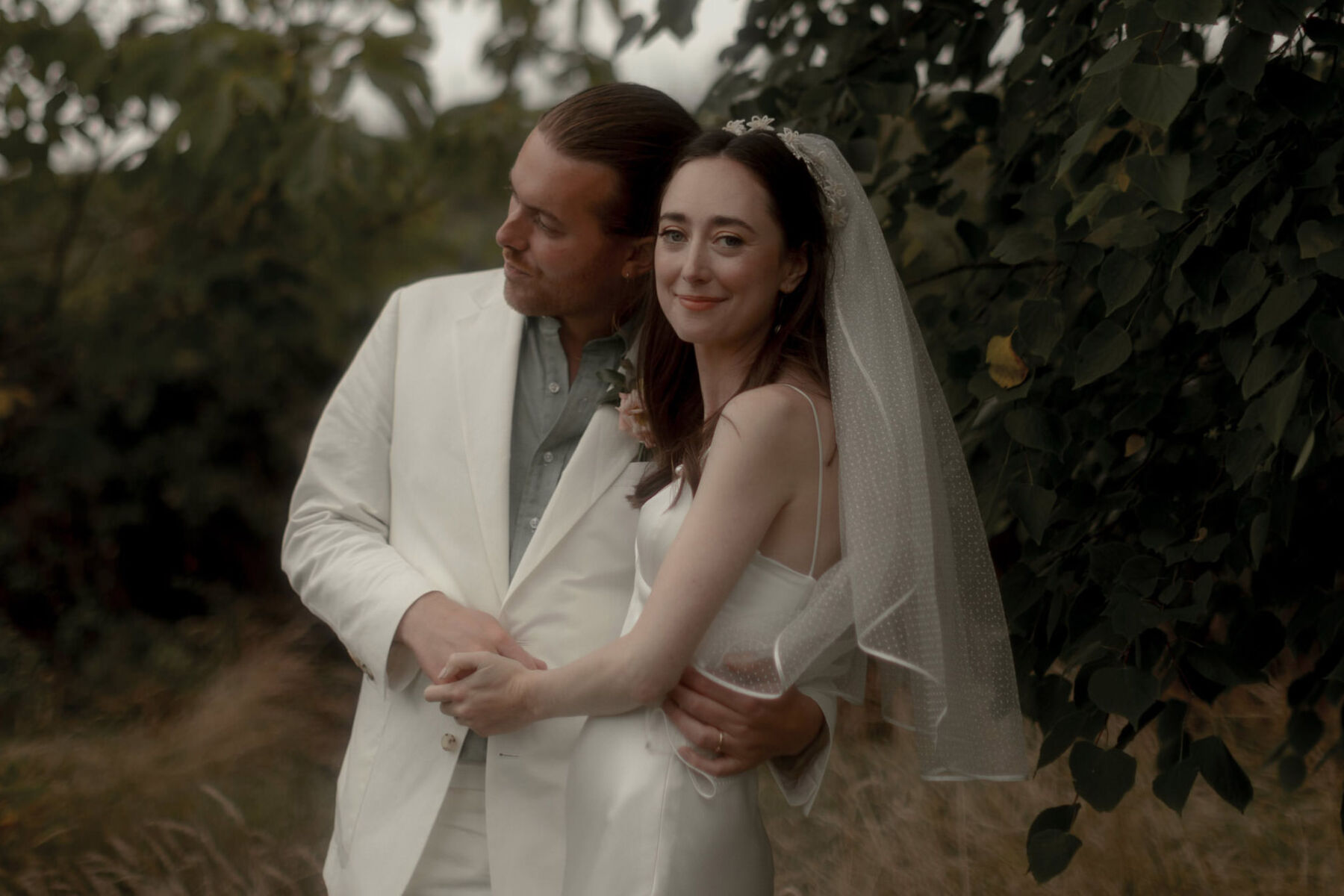 Galvan wedding dress groom in white suit