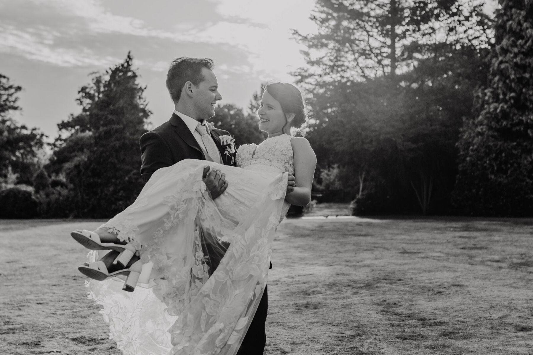 Groom lifts his bride. She wears Essense of Australia wedding dress. Shelby Ellis Photography.
