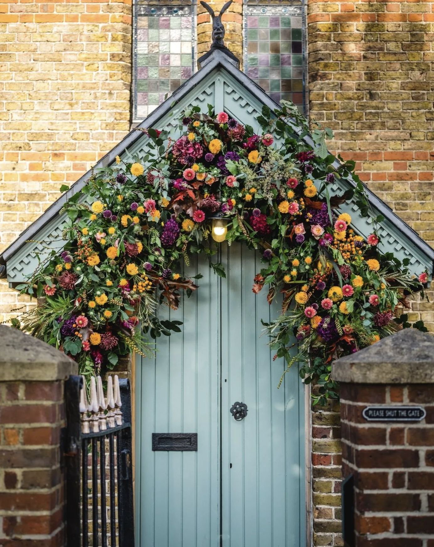 Floral arch over the door at Miss Bush bridal boutique in Ripley, Surrey. 