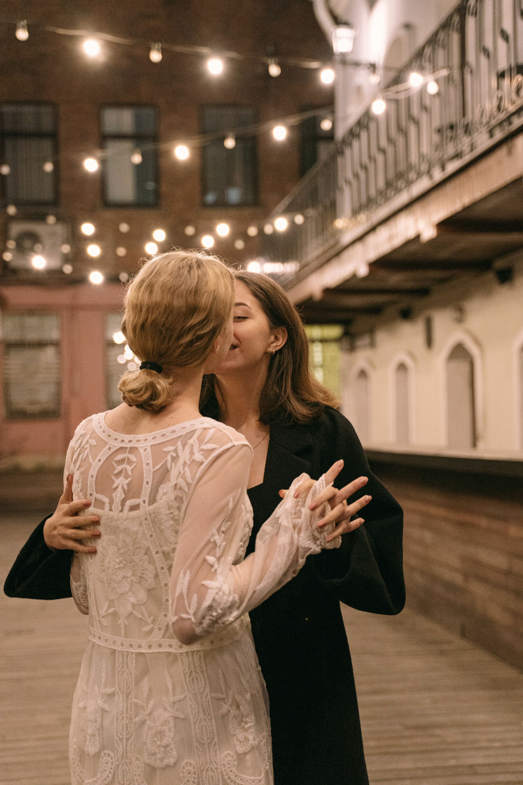 Lesbian couple kissing on their wedding day: Patchwork alternative wedding gift ideas