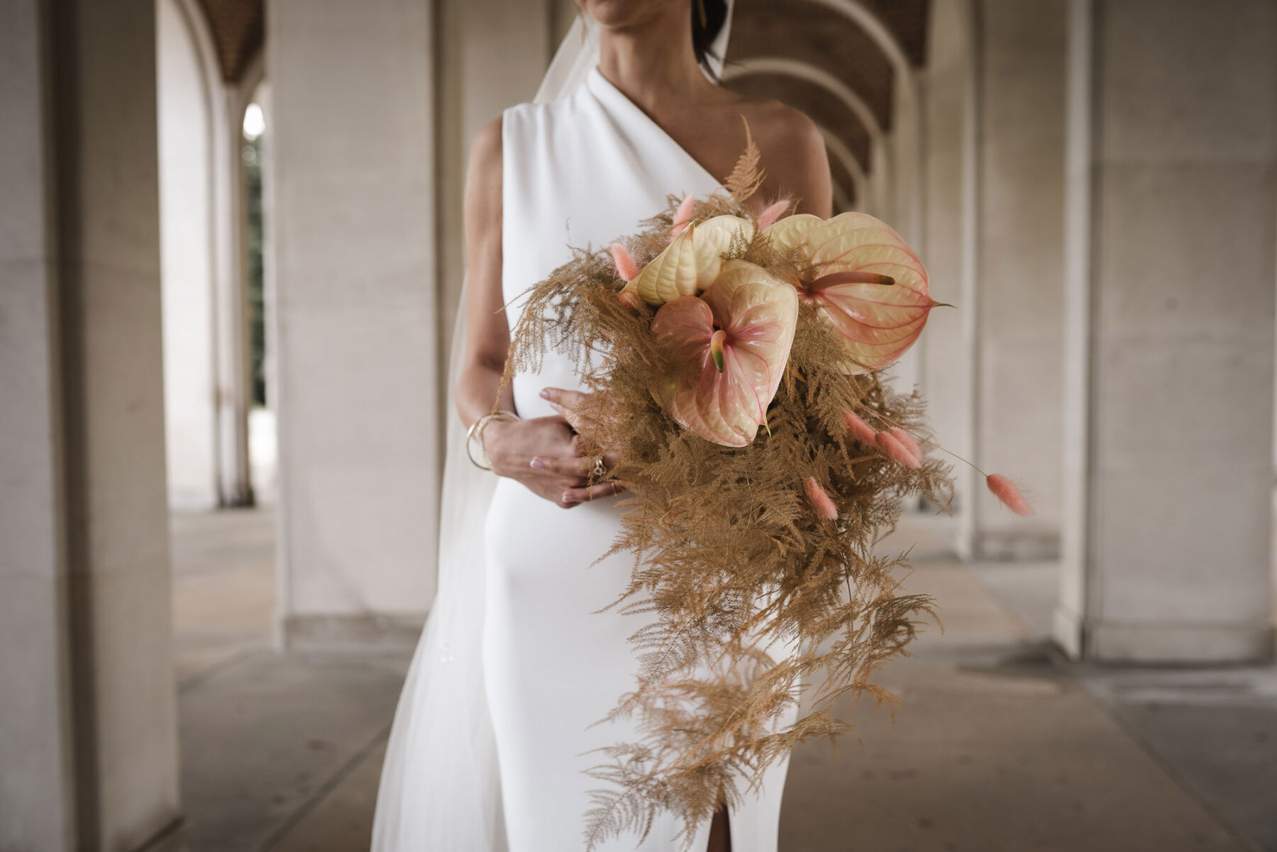 Modern wedding bouquet with bleach dried ferns + Lillies.