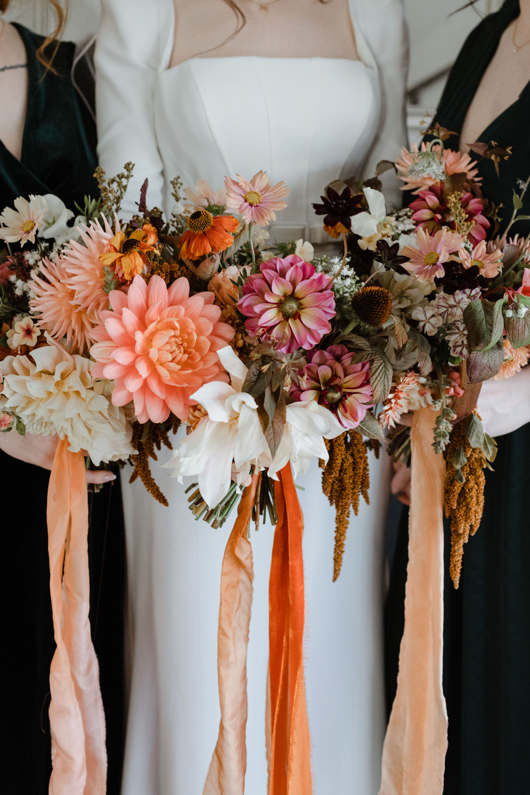 Colourful Autumn wedding bouquets with red and orange ribbons