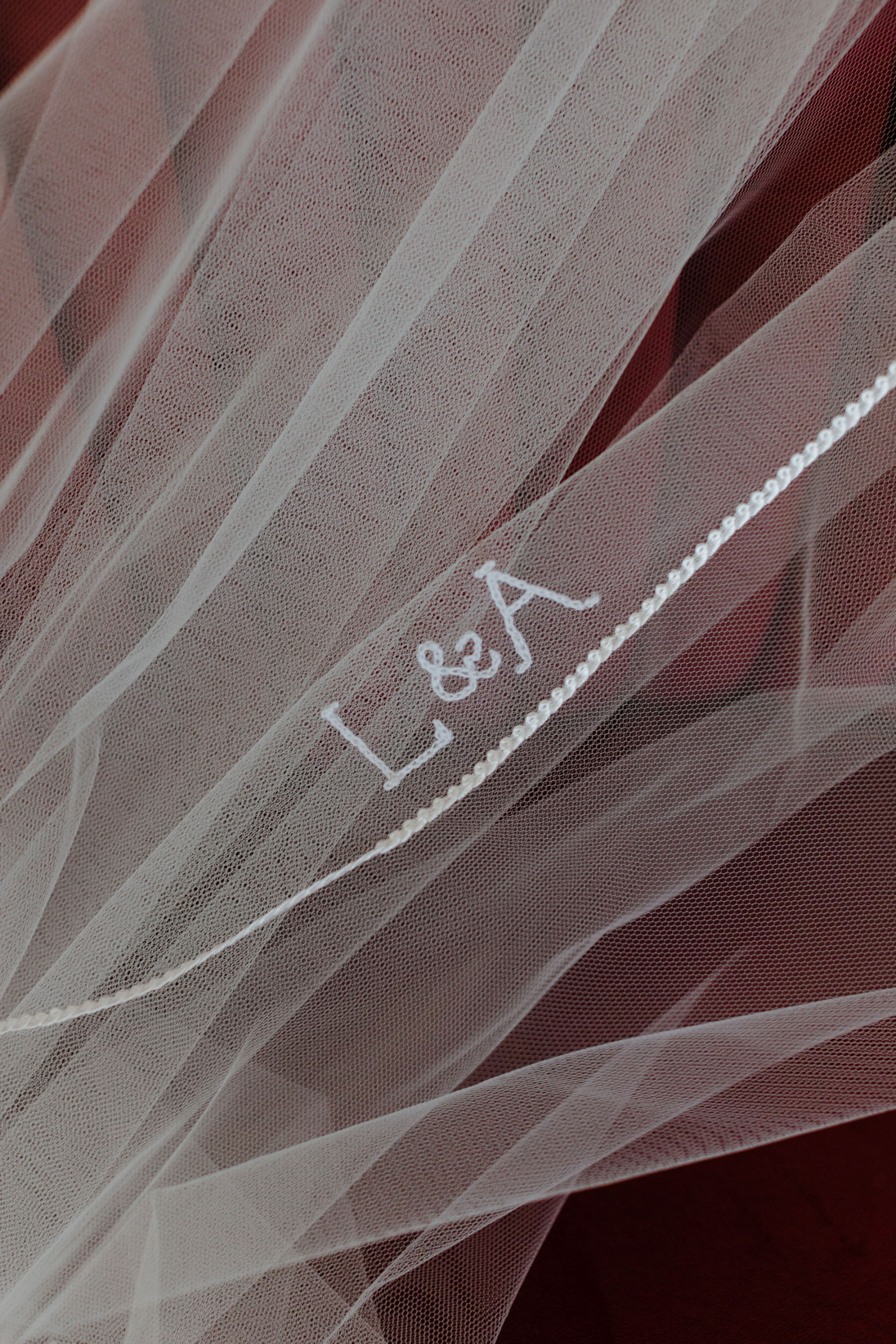 Wedding veil embroidered with initials of the bride and groom