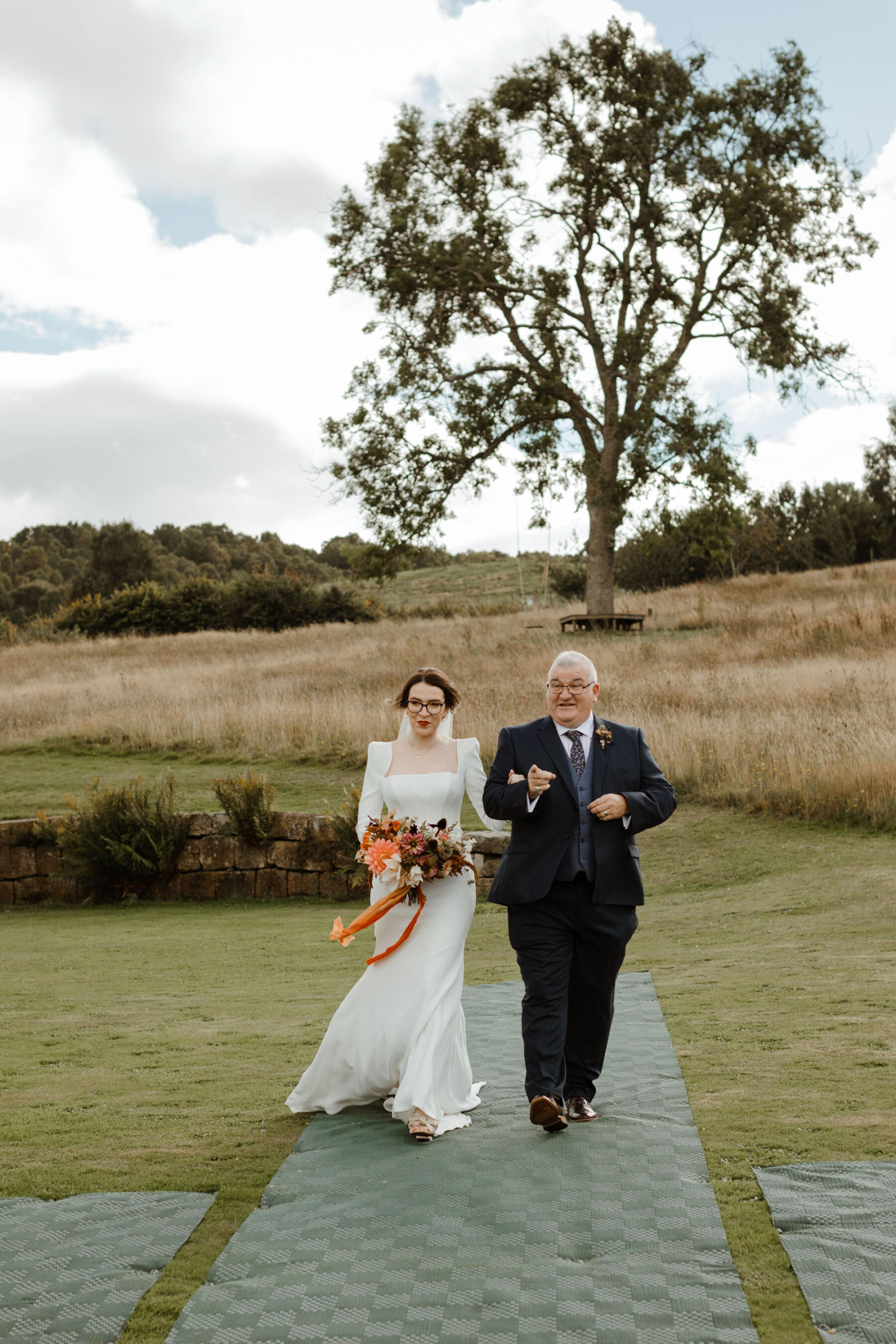 Bride in Amber by Suzanne Neville with father of the bride walking down the aisle