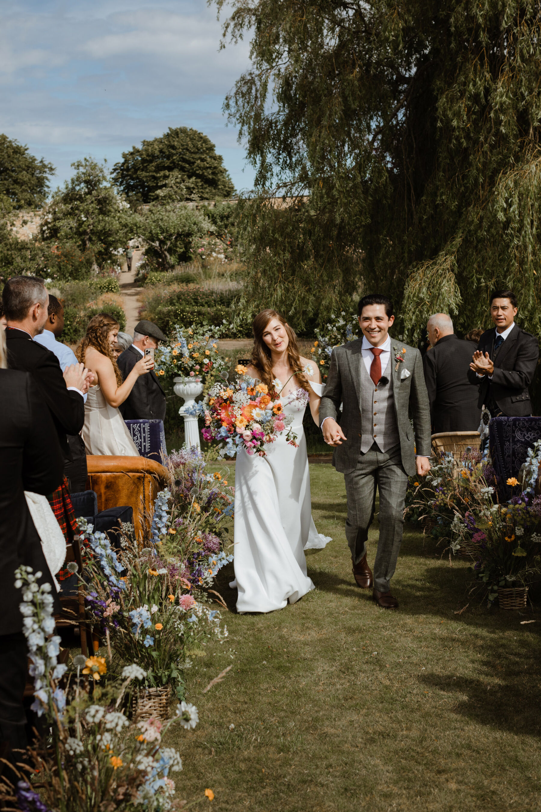Outdoor wedding cermeony lined with A Cambo Estate wedding